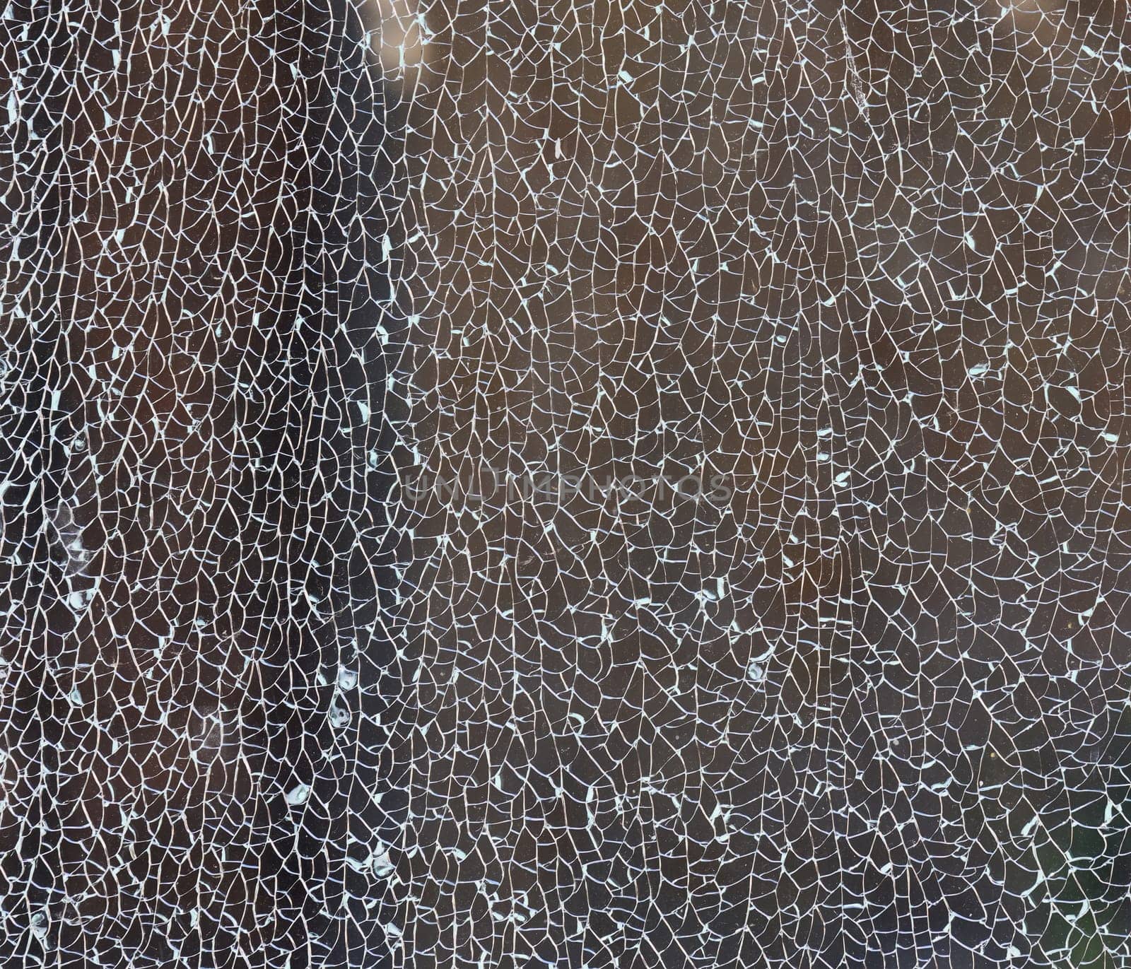 Cracked clear glass full frame. Close up