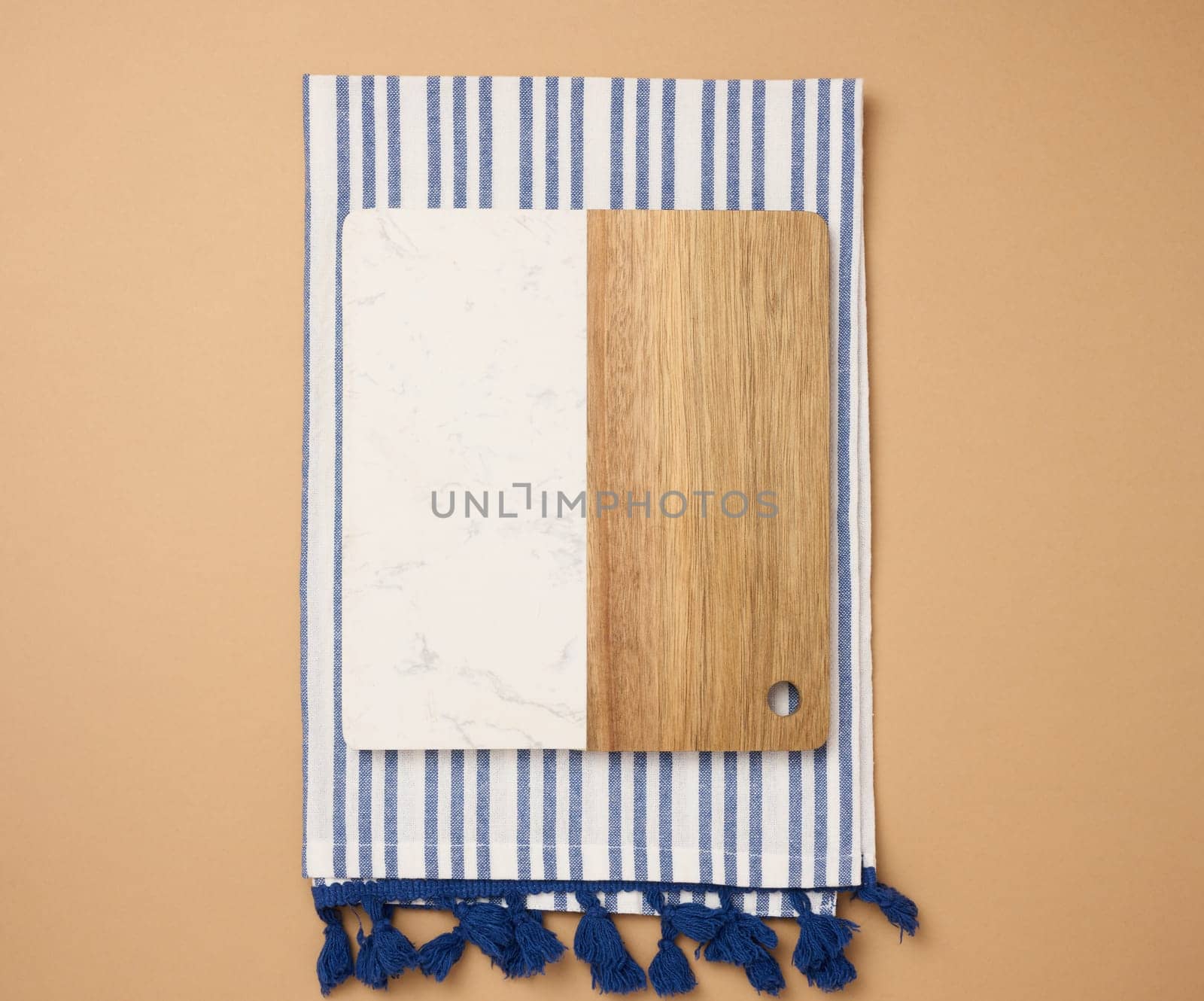Empty  wooden kitchen cutting board on brown background, top view