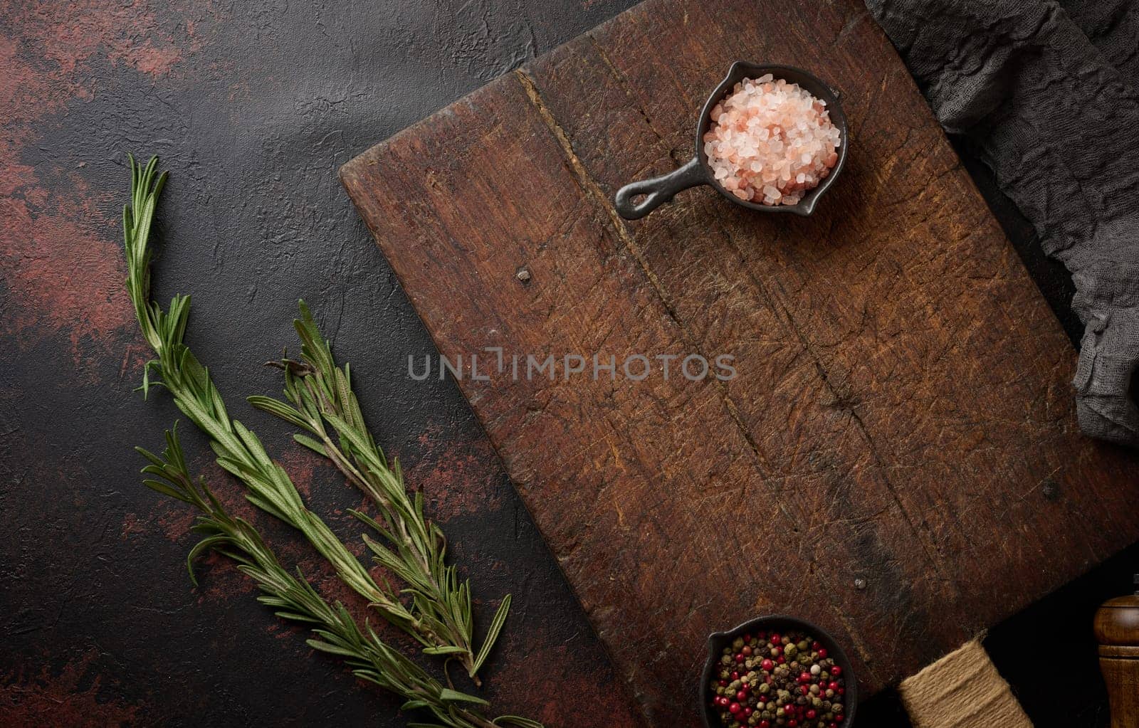 Empty brown wooden board and spices, top view