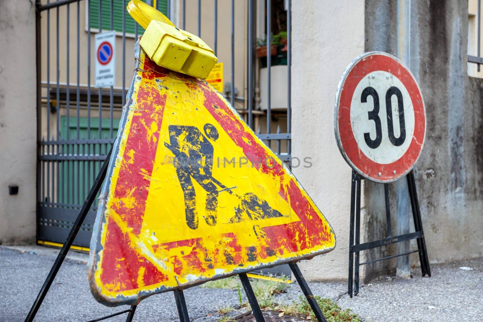 Men at work road sign. Warning of construction works ahead. Grunge look.