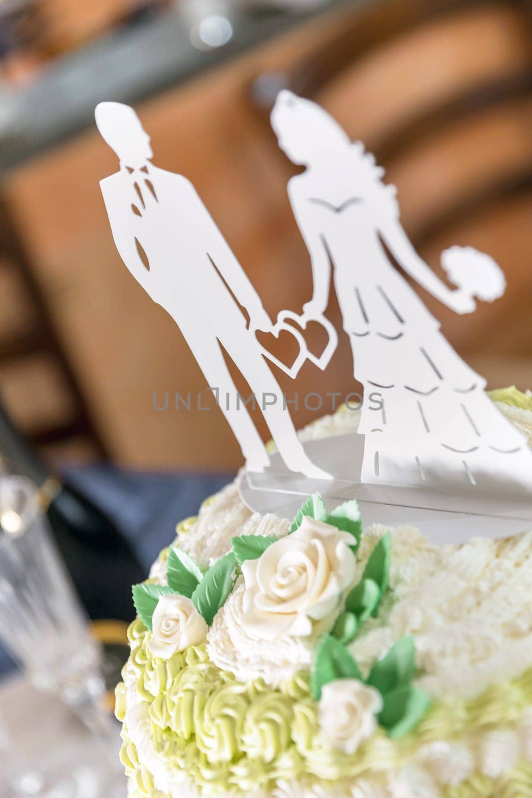 Elegant wedding cake in pastel colors with kitsch decorations