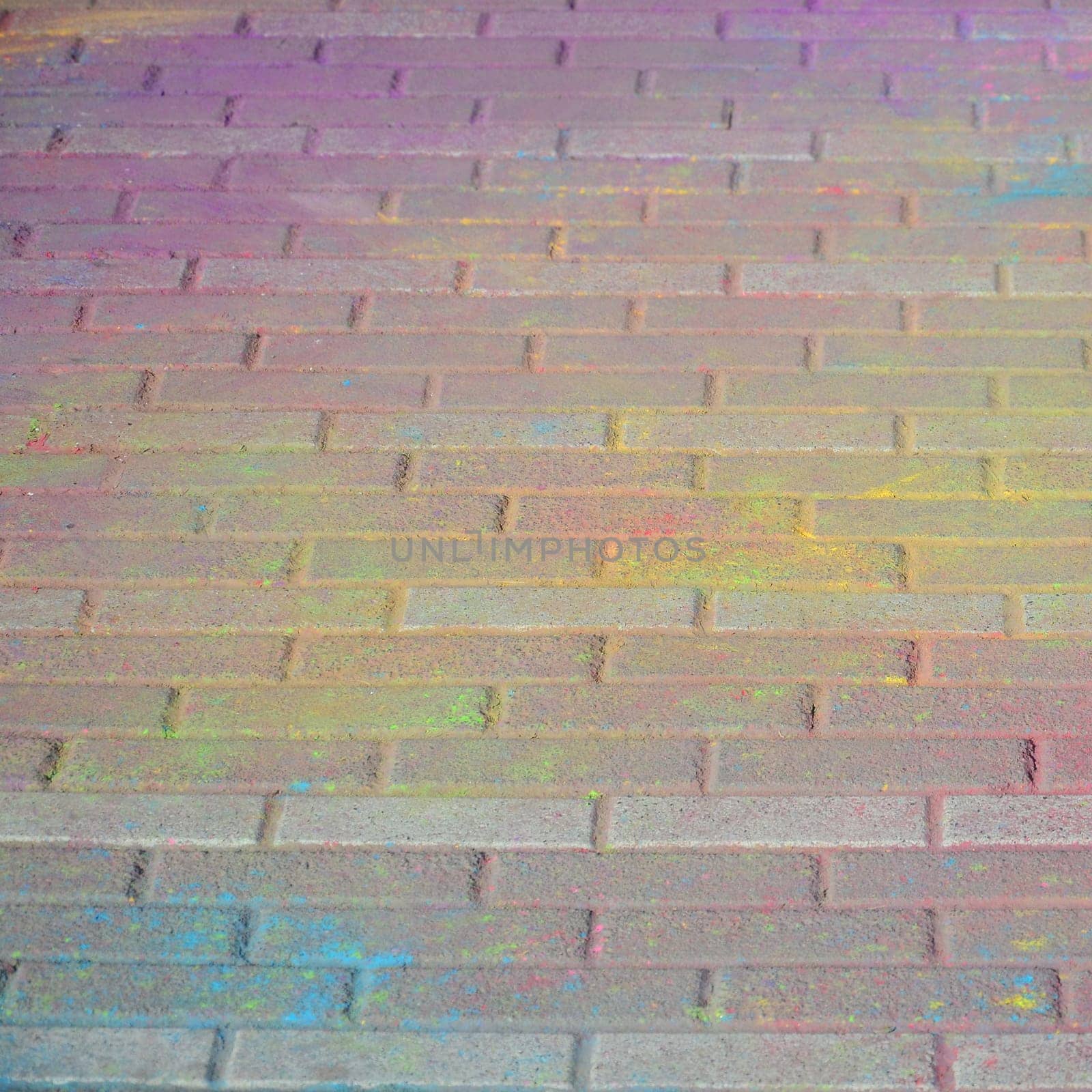 Multi colored earth, paving slabs, powder coated with dry colors at the Holi festival close up