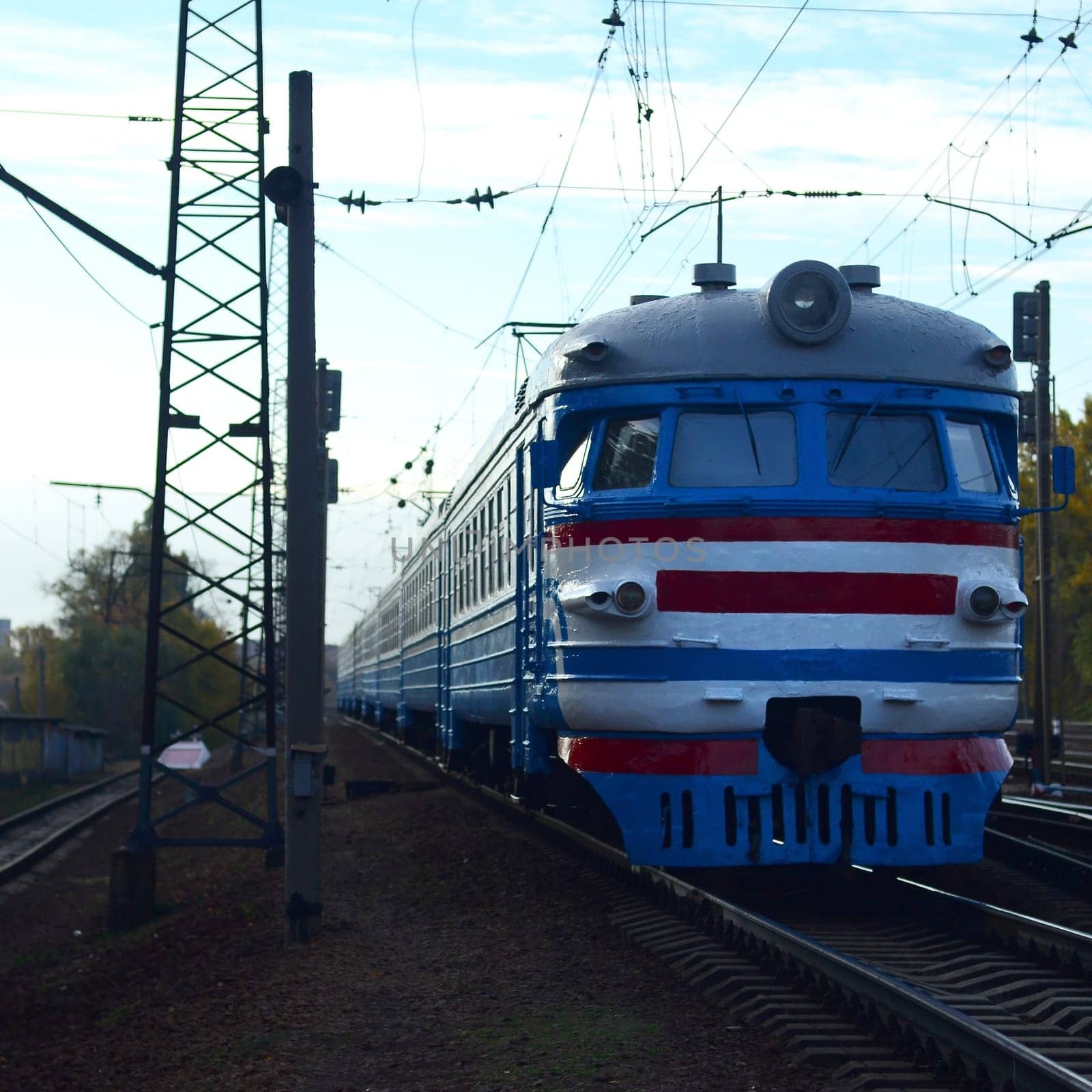 Suburban electric train. Old soviet electric train with outdated design moving by rail. Transportation concept