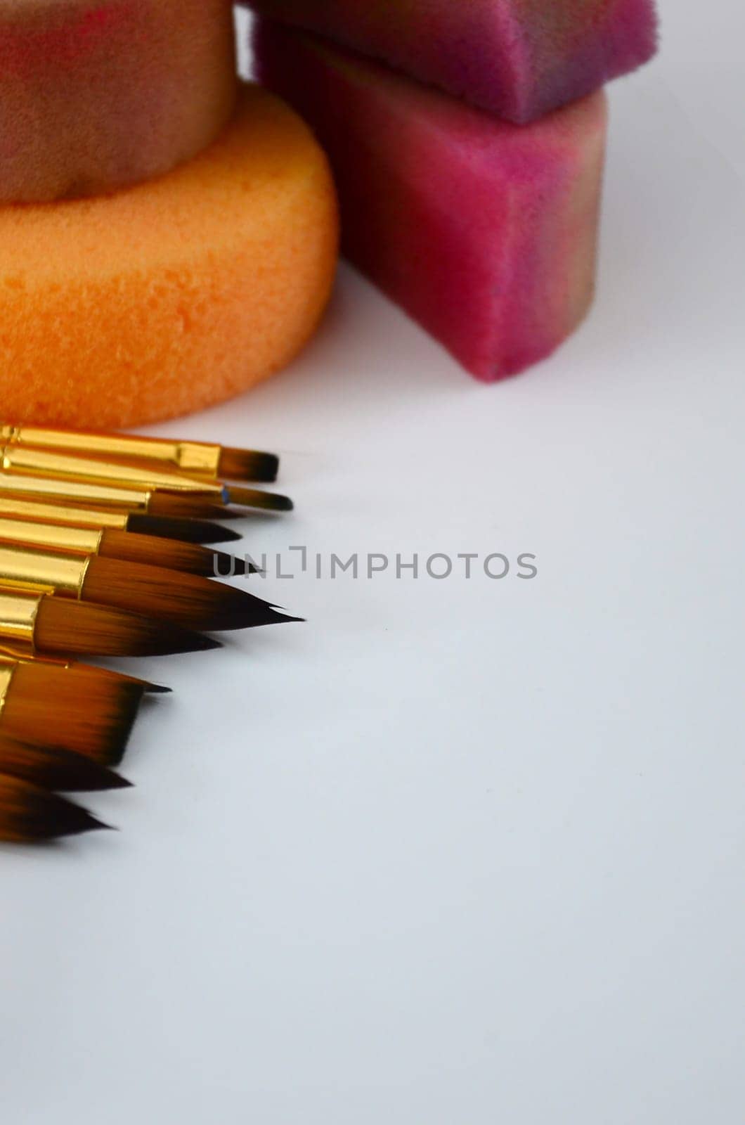 Color cosmetics, brushes and sponges for face painting on white background. Children party concept