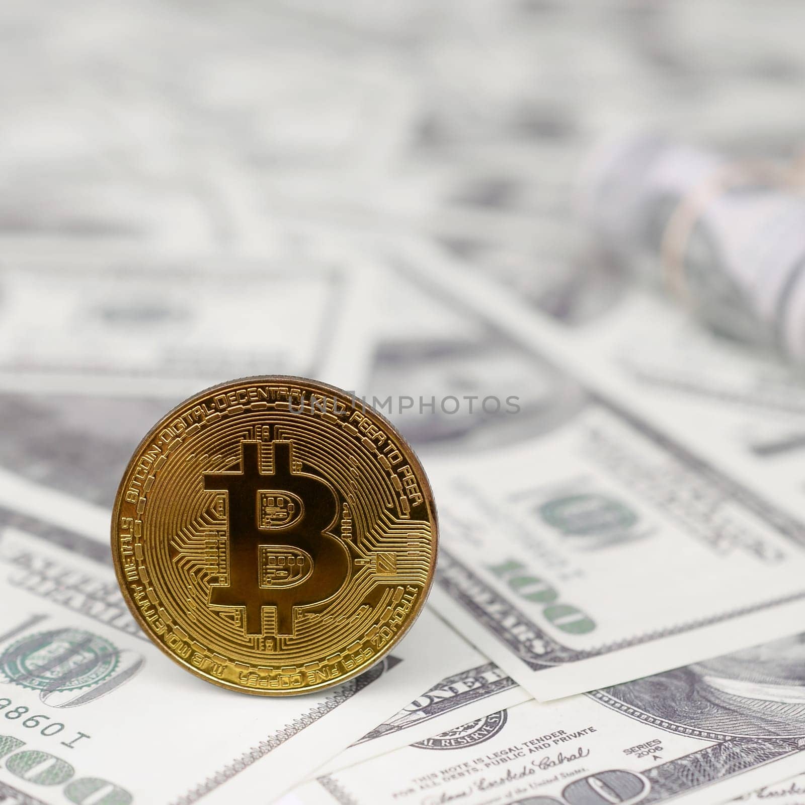 Bitcoin coin and banknotes of one hundred dollar. The concept of reasonable and proper investment of money in cryptocurrency. Earnings in crypto market