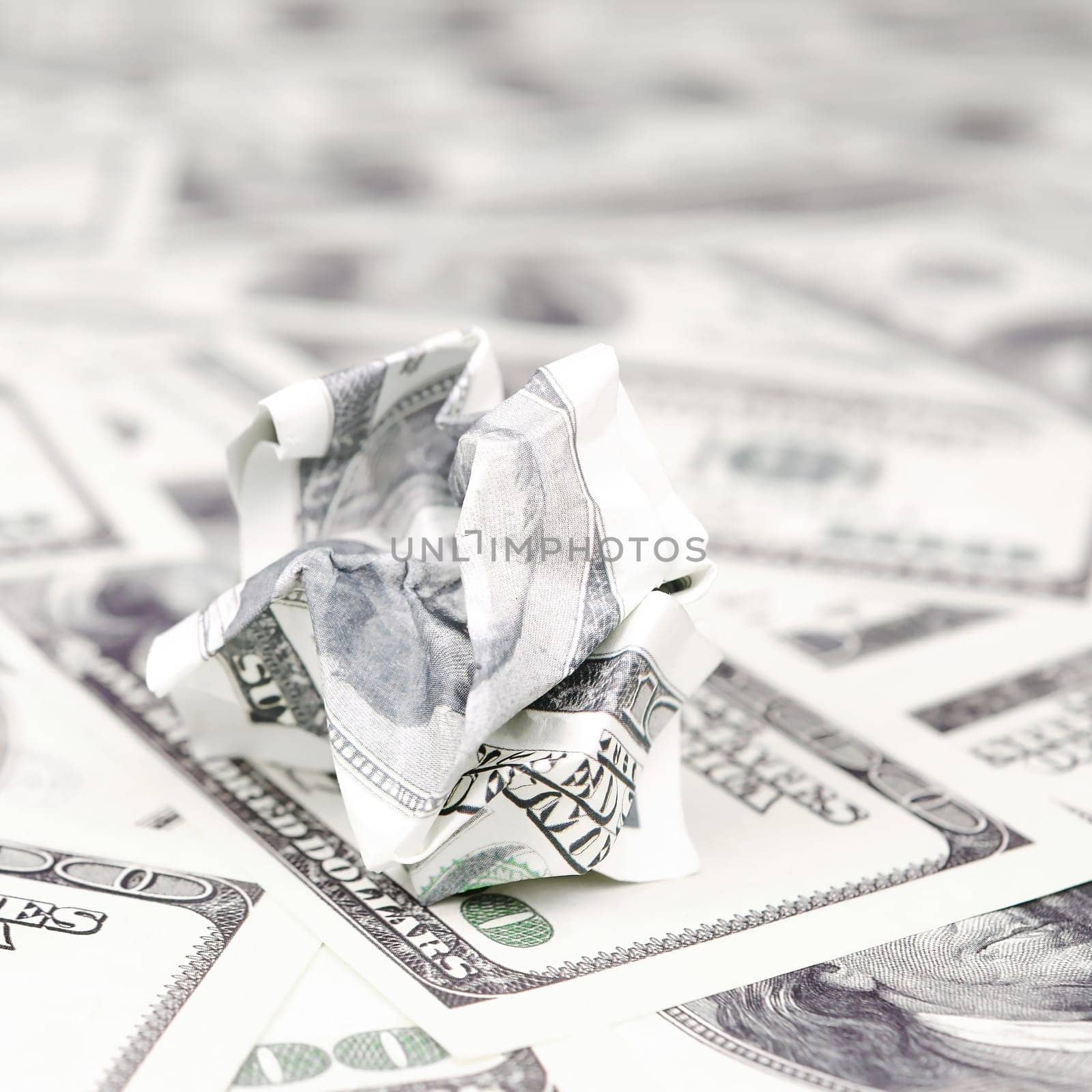Crumpled dollar bill of the United States lies on the set of smooth money bills. Concept of unreasonable waste of money