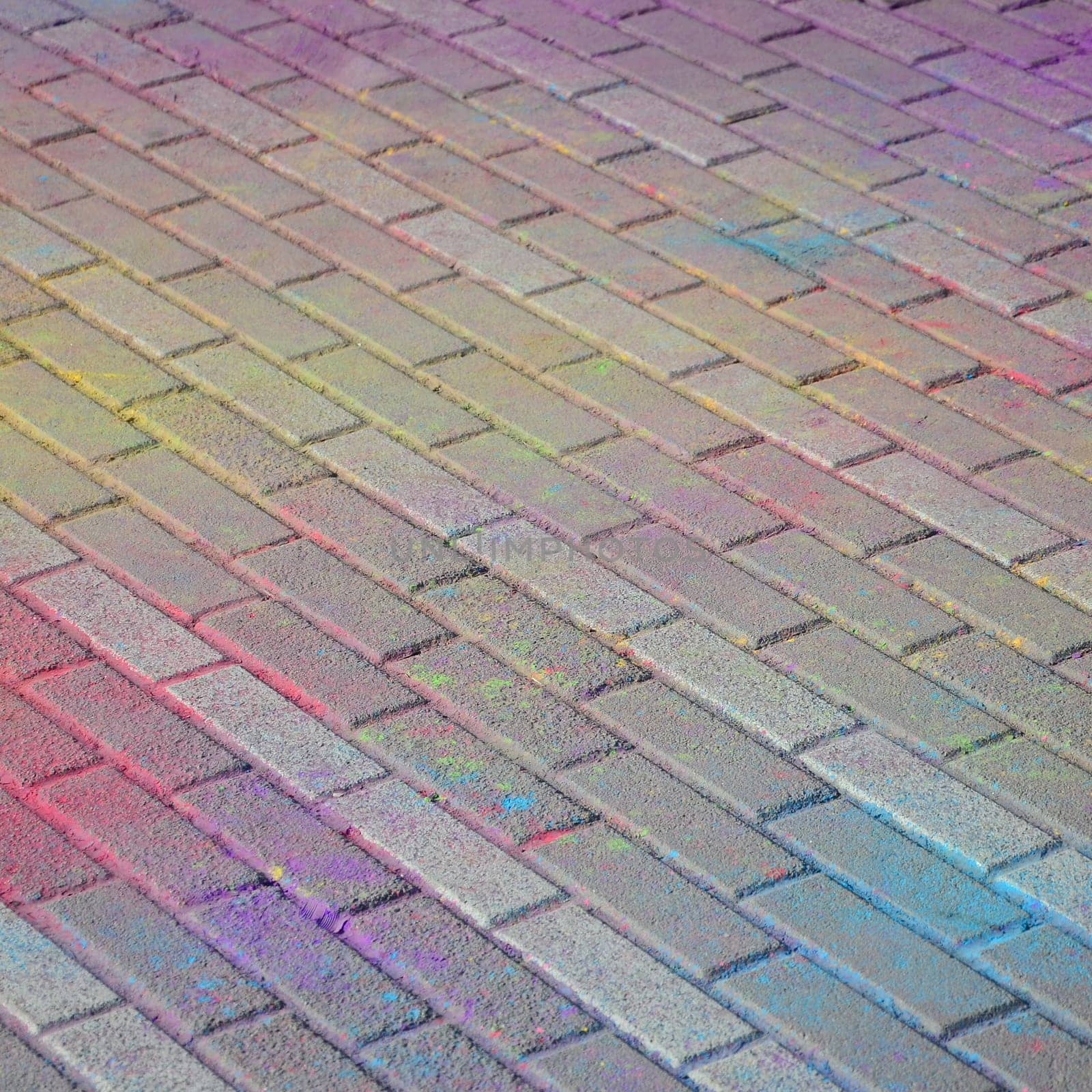 Multi colored earth, paving slabs, powder coated with dry colors at the Holi festival close up