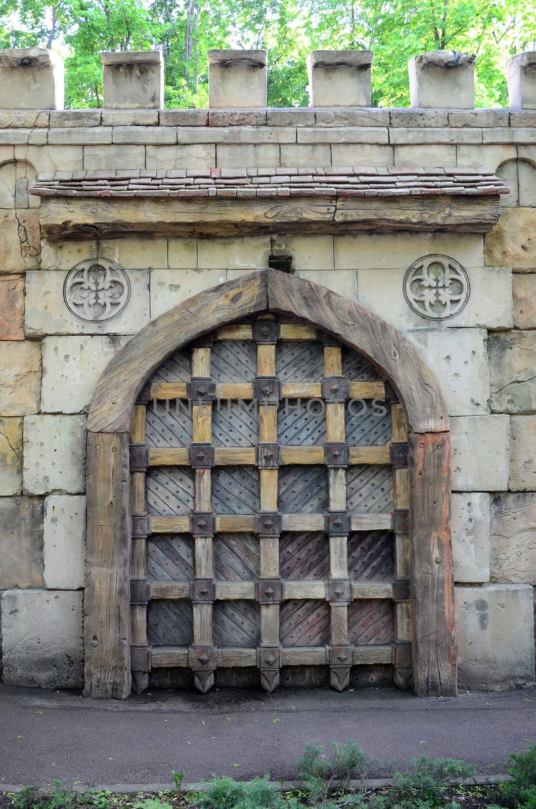 Old style wooden door from medieval era. Entrance to an antique place close up