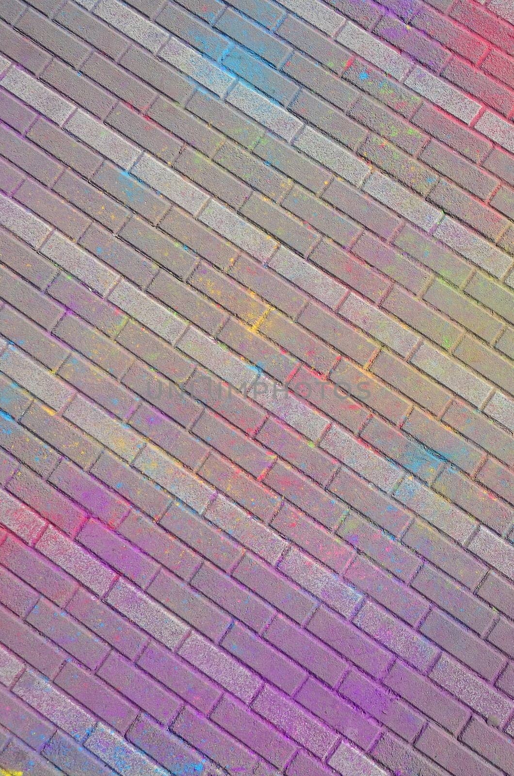 Multi colored earth, paving slabs, powder coated with dry colors at the Holi festival close up