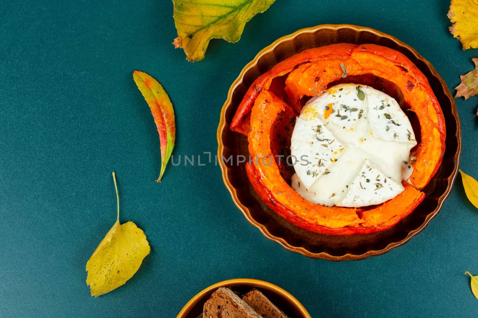 Pumpkin baked with camembert cheese in a pumpkin. Healthy eating.