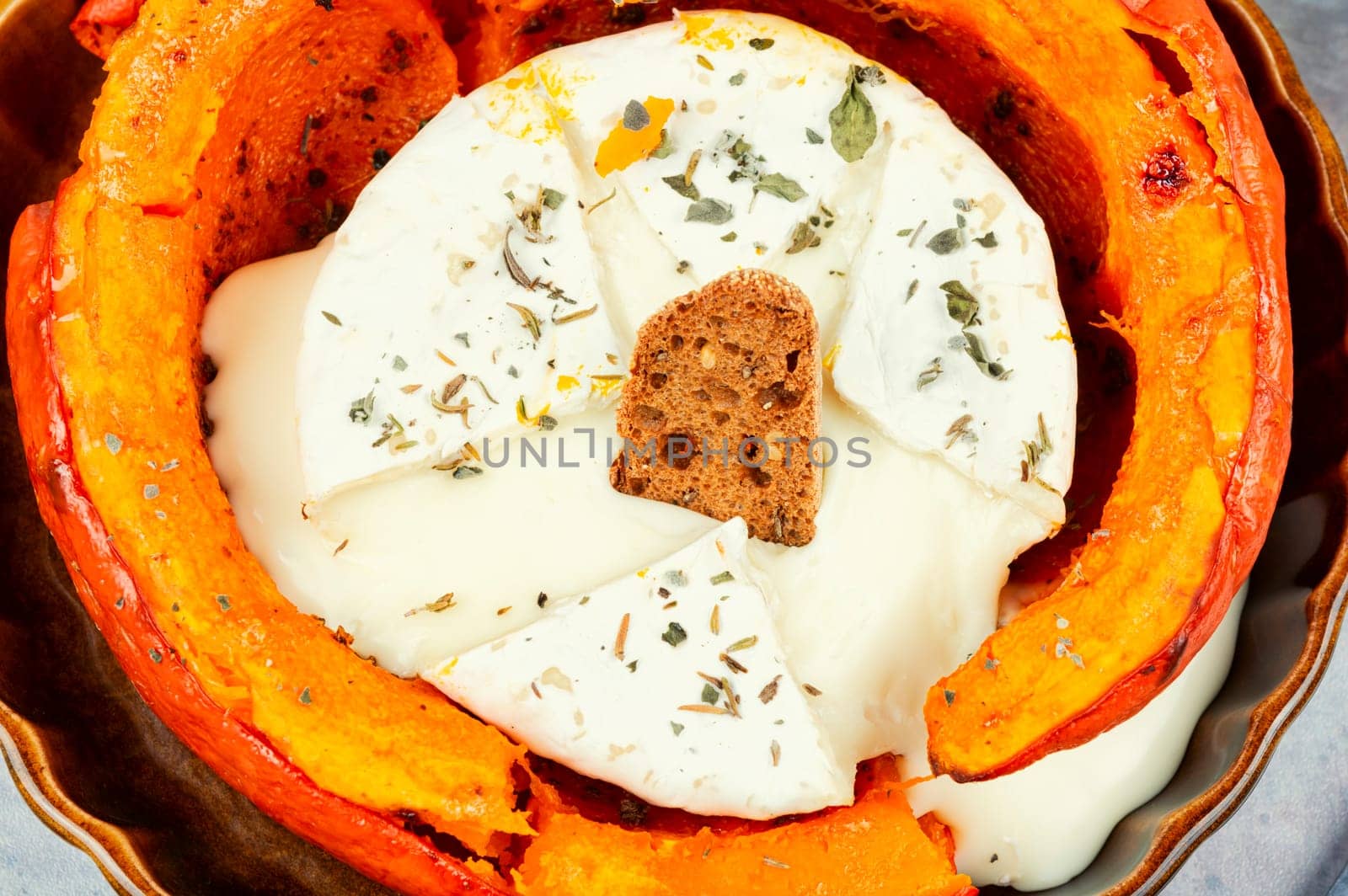 Pumpkin baked with camembert cheese in a pumpkin. Healthy eating.