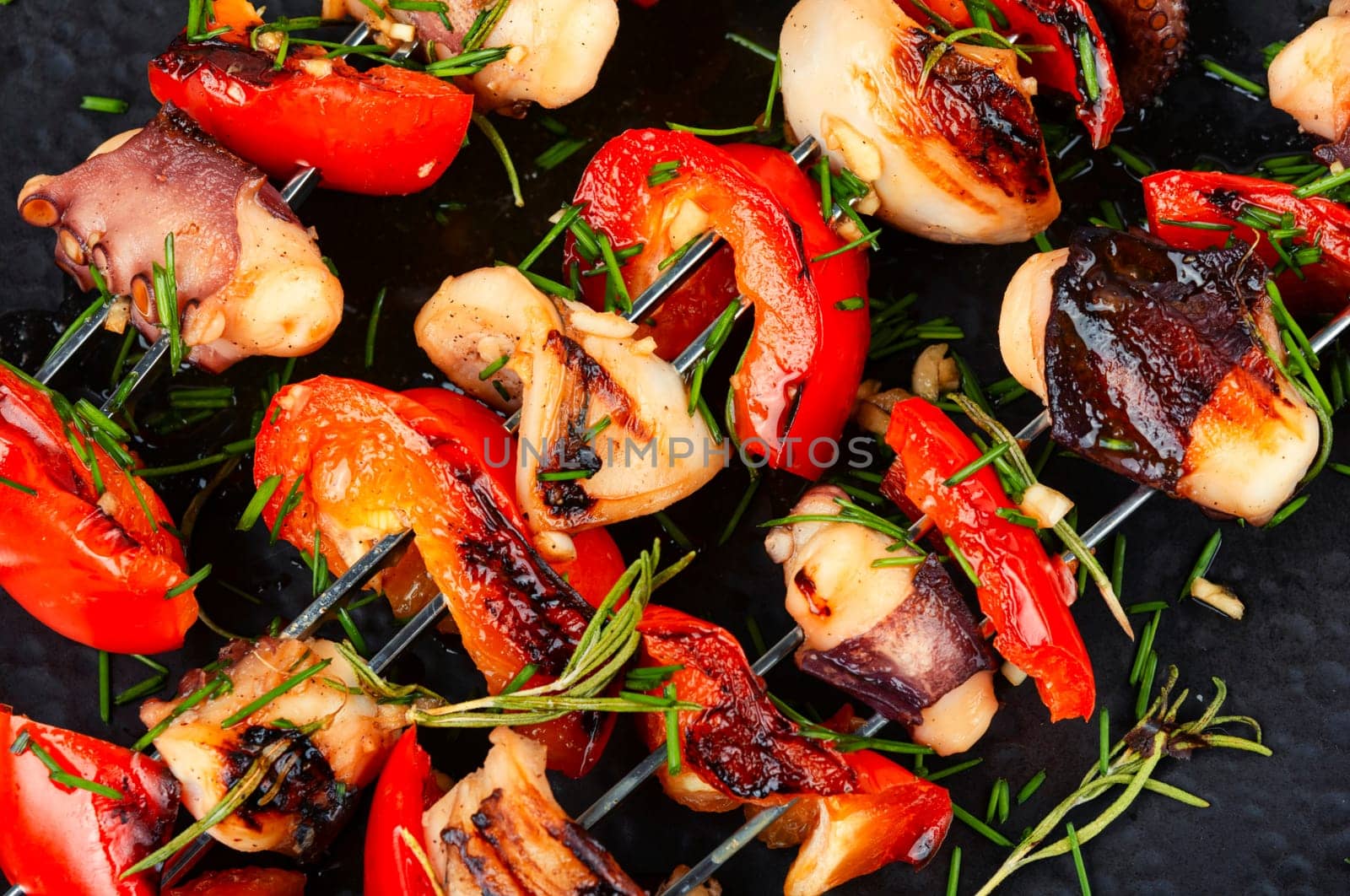 Delicious octopus dish, grilled octopus on skewers. Skewers of squid tentacles, octopus.