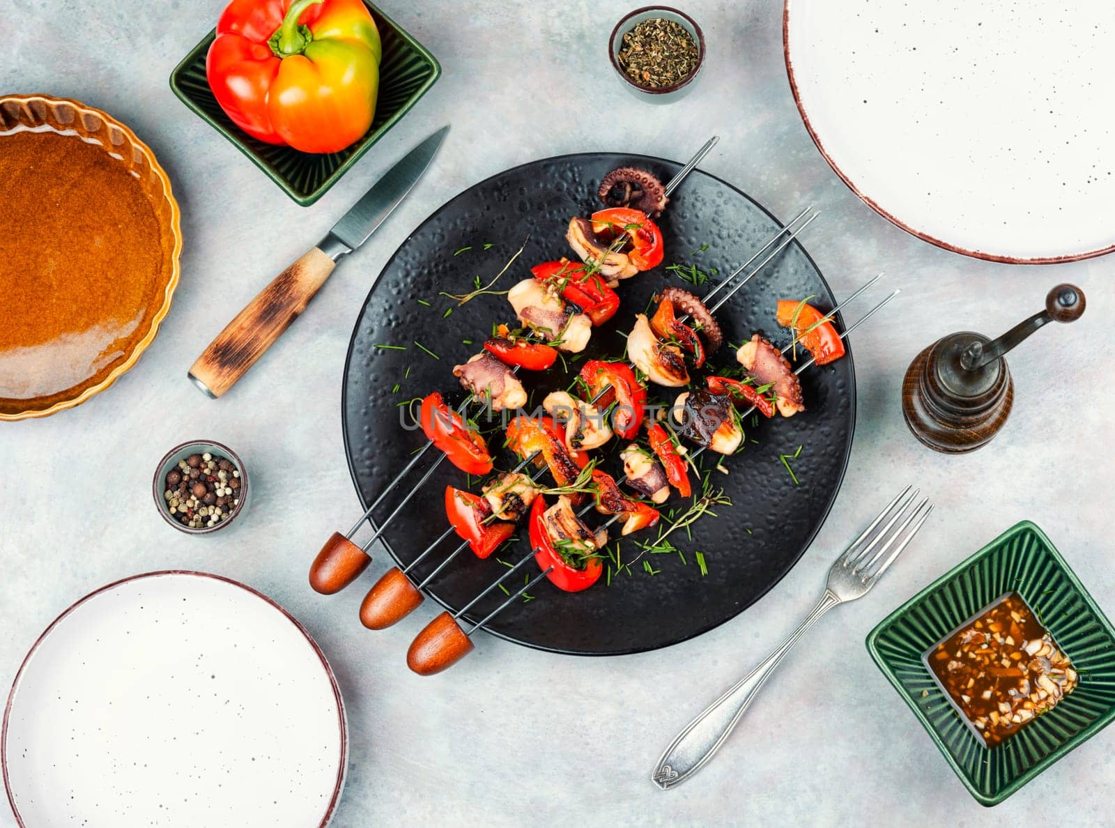 Delicious octopus dish, grilled octopus on skewers. Skewers of squid tentacles, octopus.