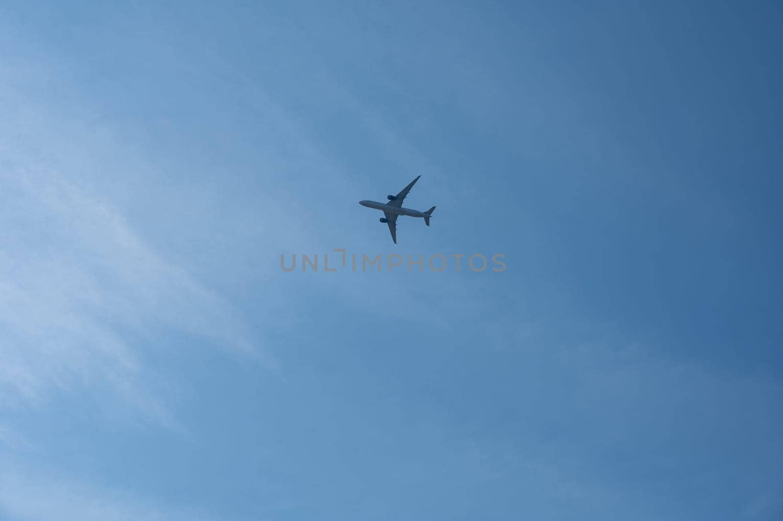 An airplane from below with a lot of sky