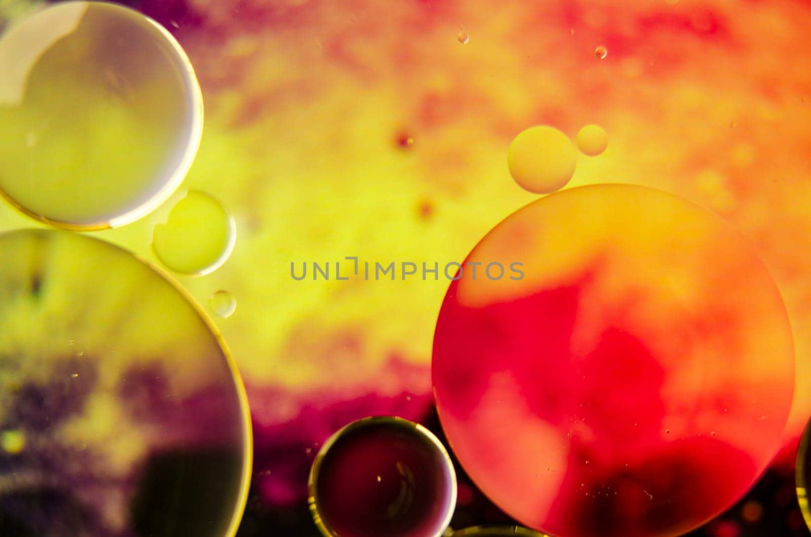 Close-up of oil bubbles forming unique shapes on a water surface, set against a subtle gradient, ideal for a dynamic wallpaper