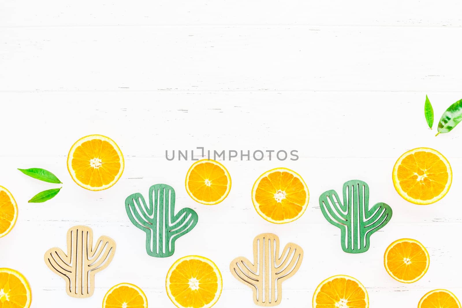 Creative scandinavian style flat lay top view of fresh orange fruit slices on white wooden table background with copy space. Minimal summer fresh citrus pattern for blog or recipe book
