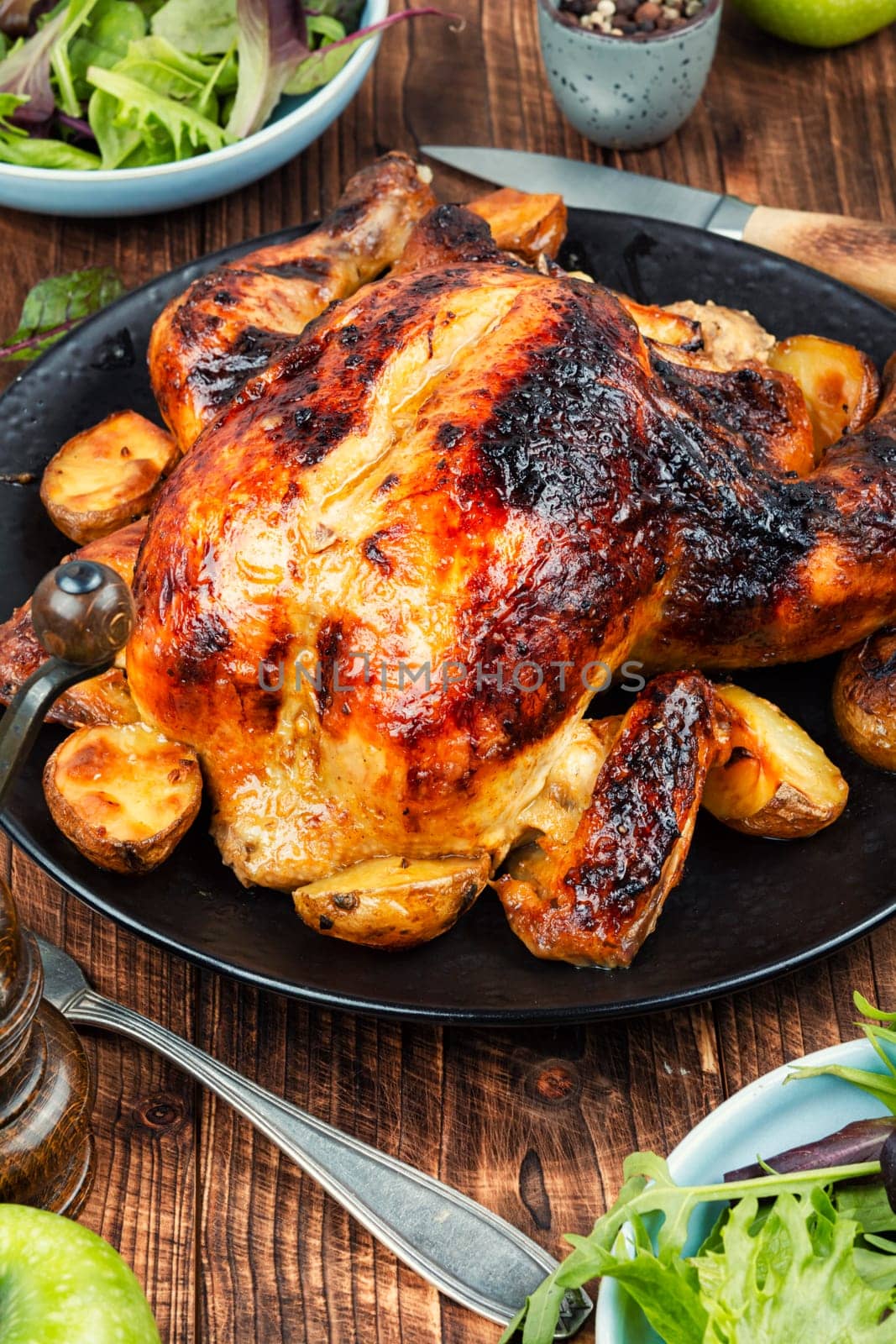 Delicious looking freshly roasted chicken. Braised chicken with aromatic herbs.