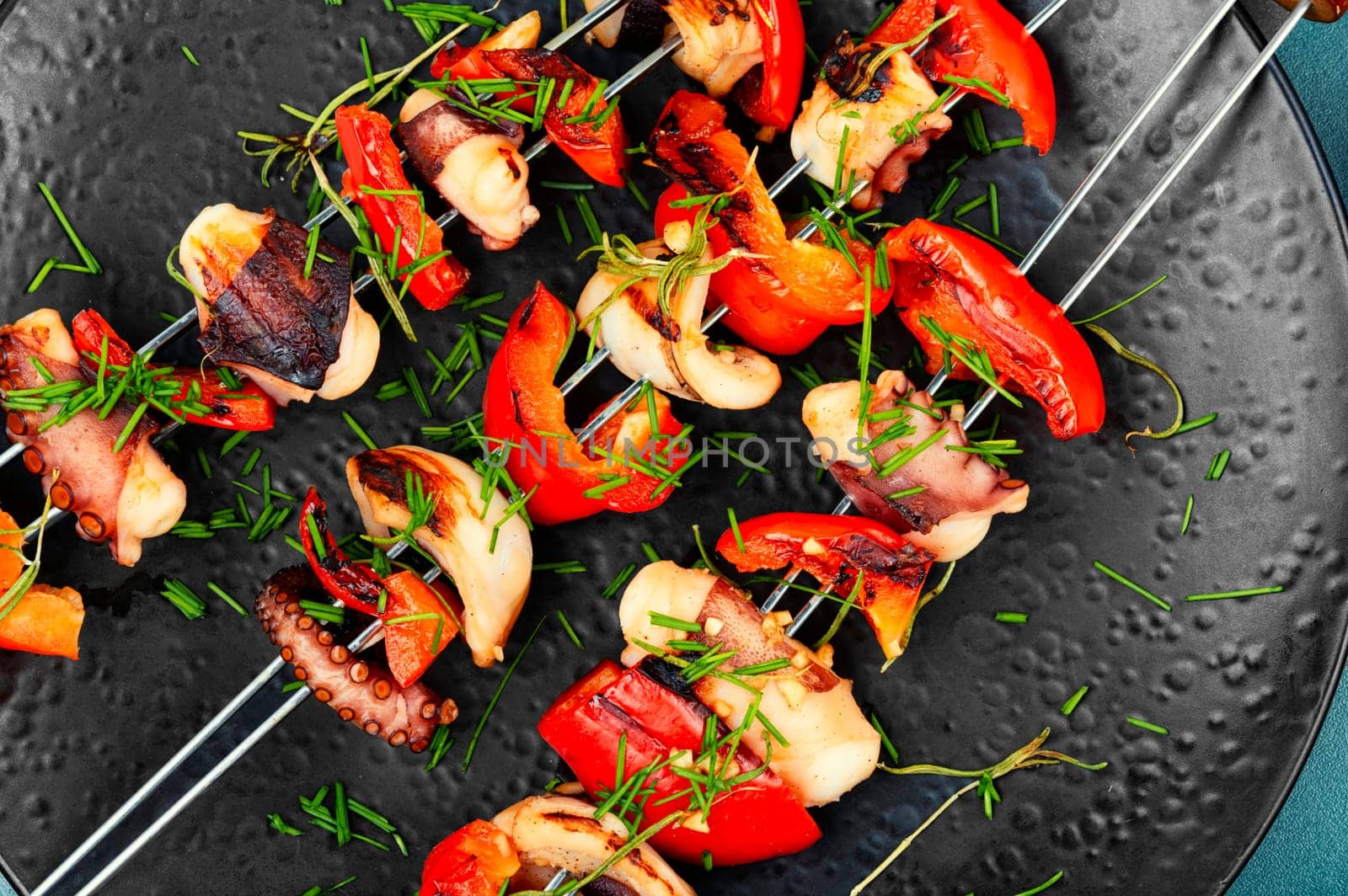 Grilled octopus, grilled squid on skewers, barbecue or BBQ squid, Grilled squid skewers. Top view.