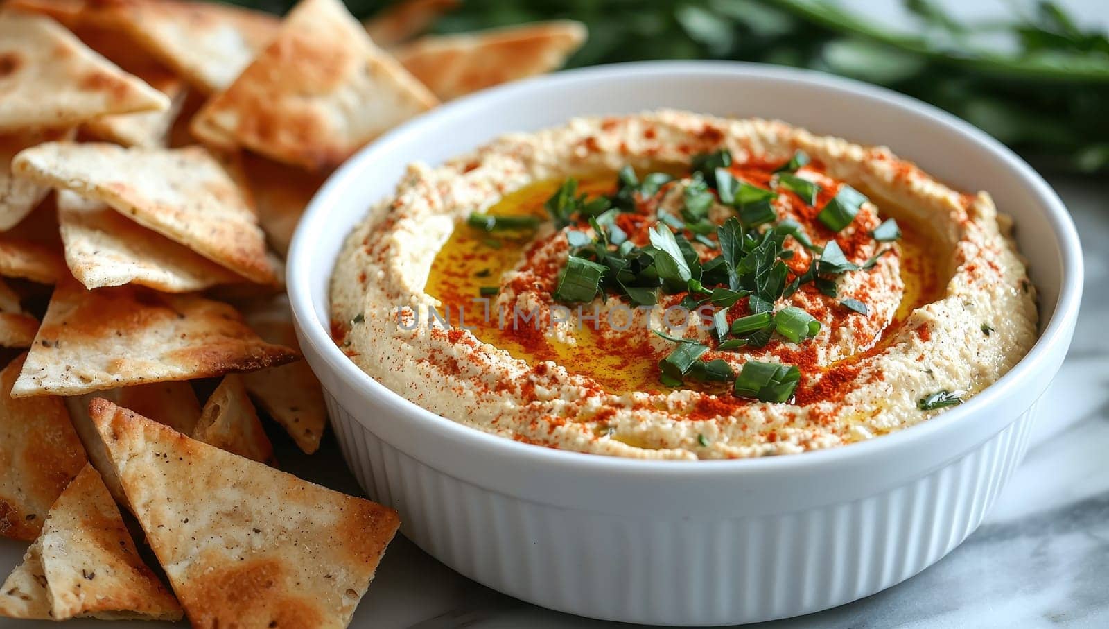 Homemade Hummus Dip with Pita Bread and Fresh Herbs