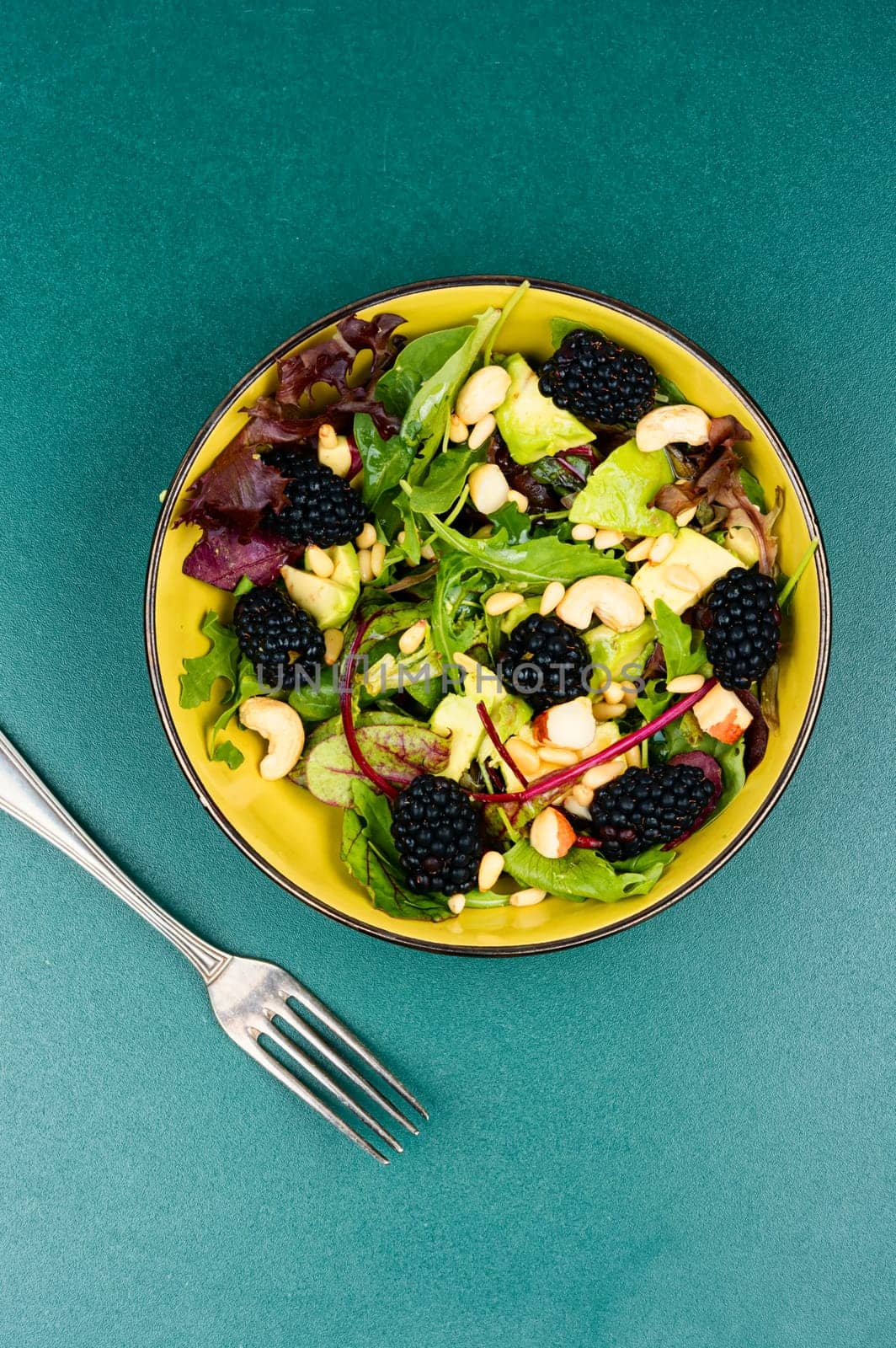 Summer food, salad with fresh blackberries garnished with fresh herbs. Healthy food. Top view.