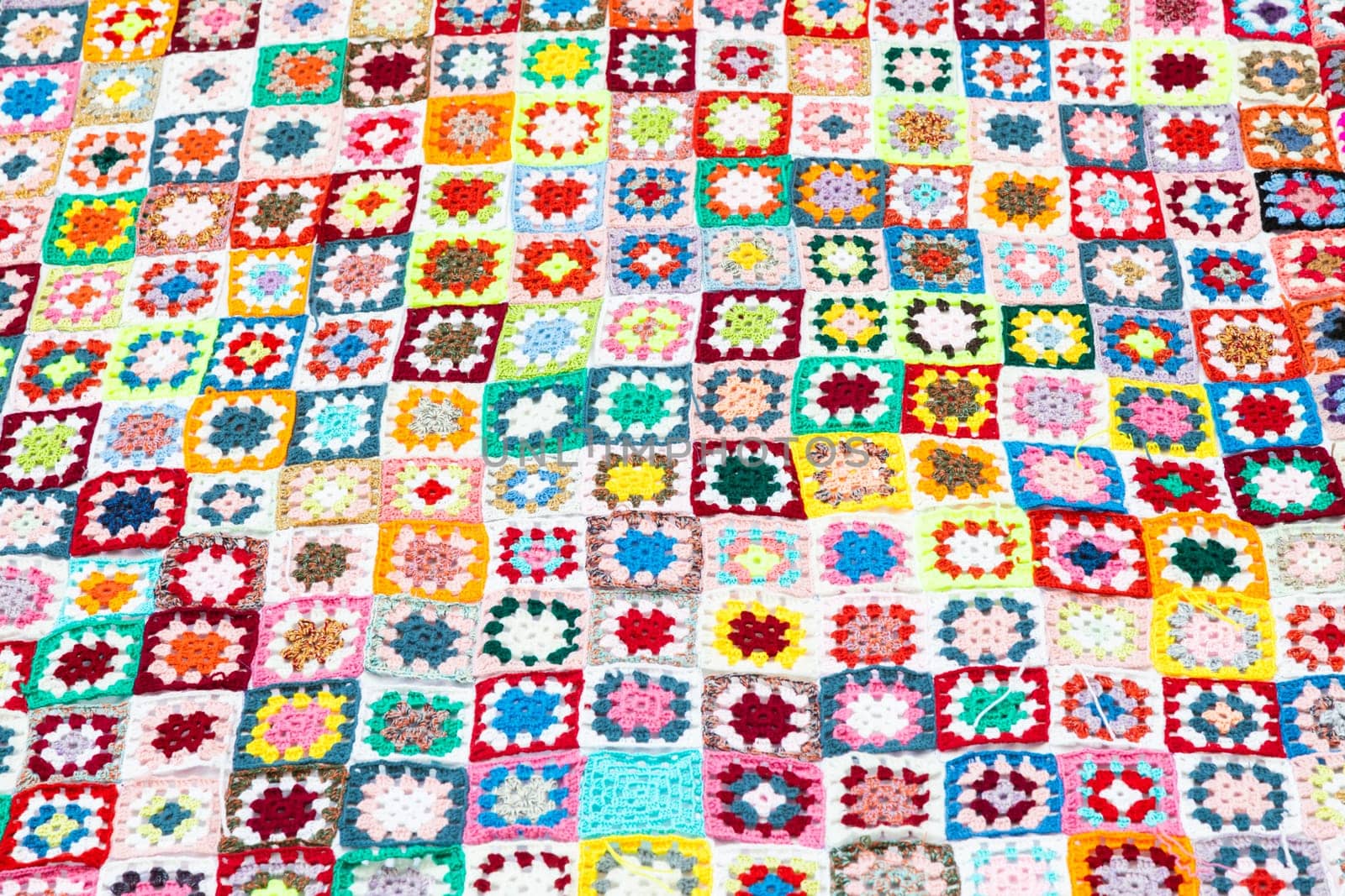 Multi colored blanket in wool, geometric background, retro decorative pattern