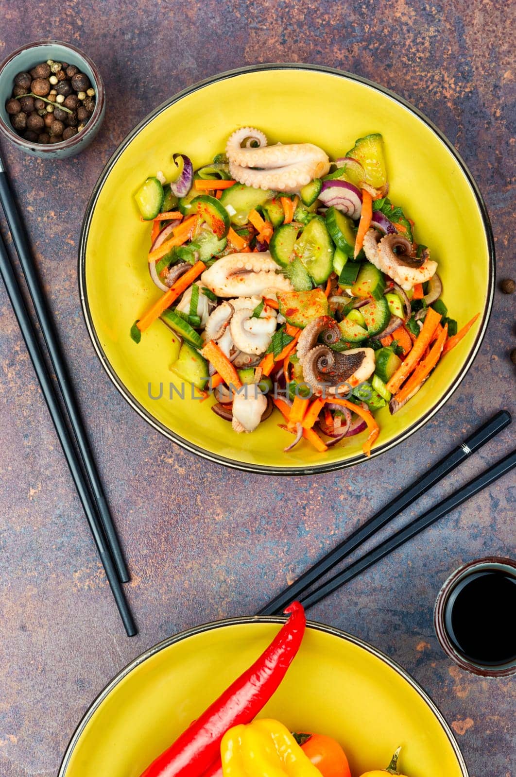 Thai spicy squid or calamari salad in plate. Space for text.