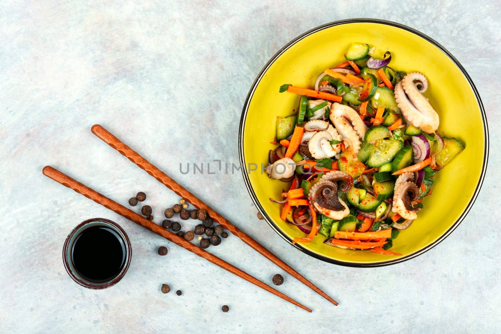 Thai spicy squid or calamari salad in plate. Space for text.