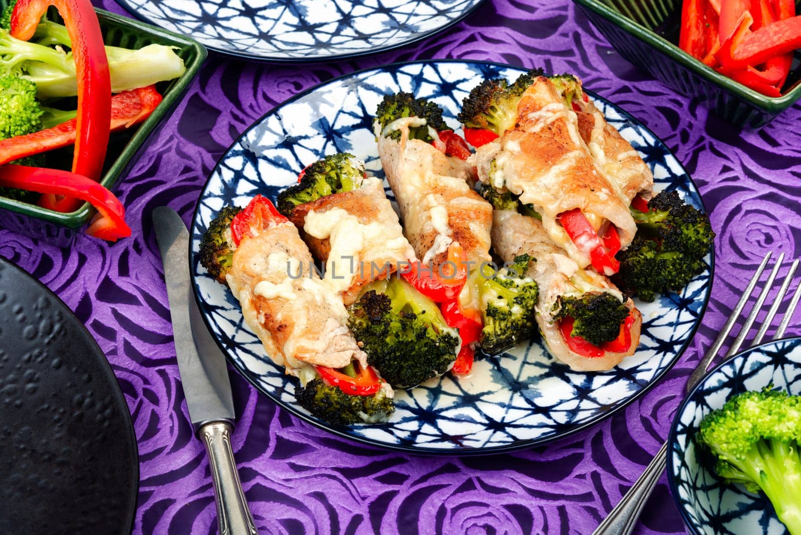 Meat rolls or roulades stuffed with broccoli and peppers. Meat with vegetable filling.