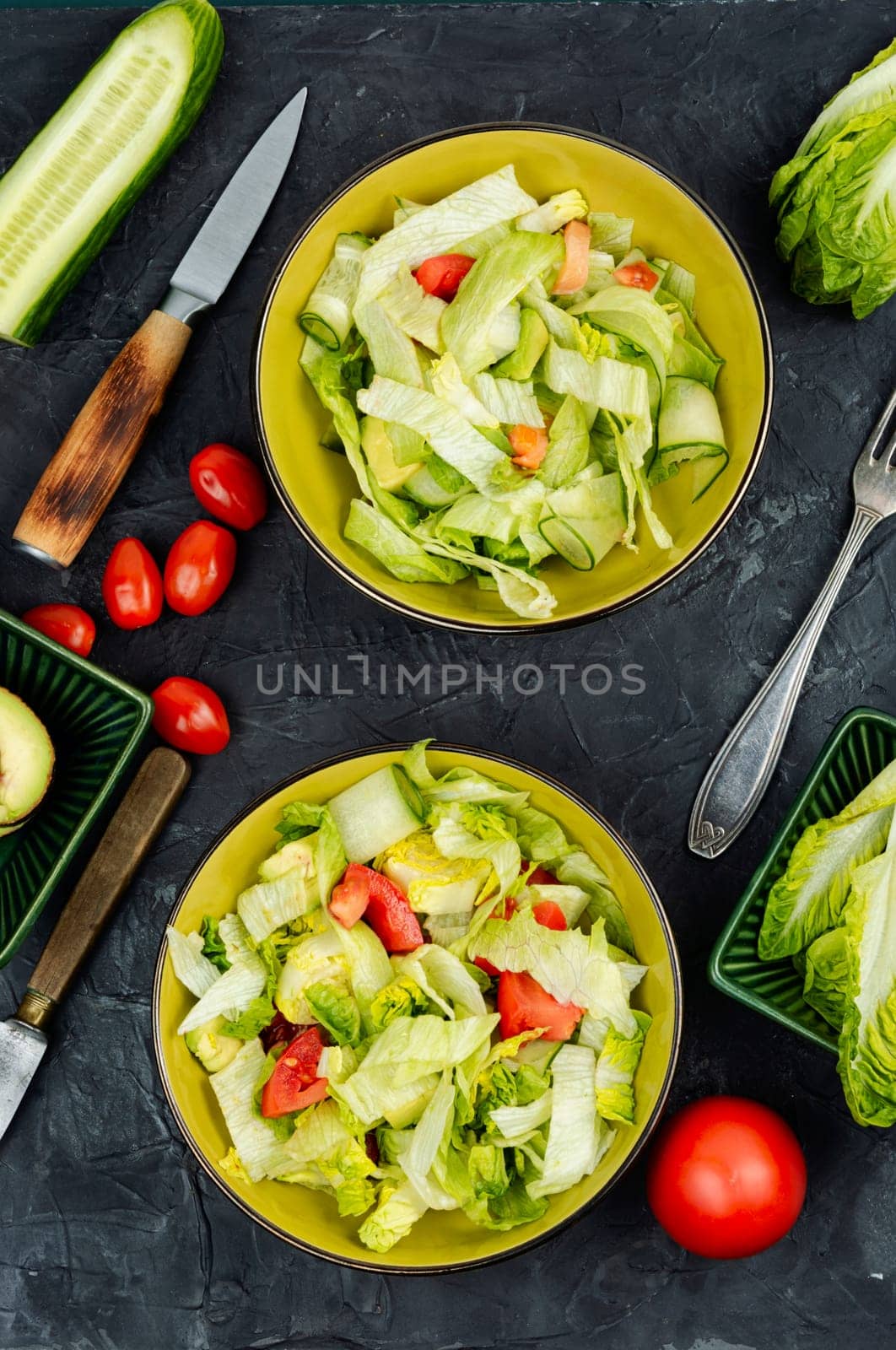 Green vegan salad made from a mixture of green leaves and vegetables. Space for text.