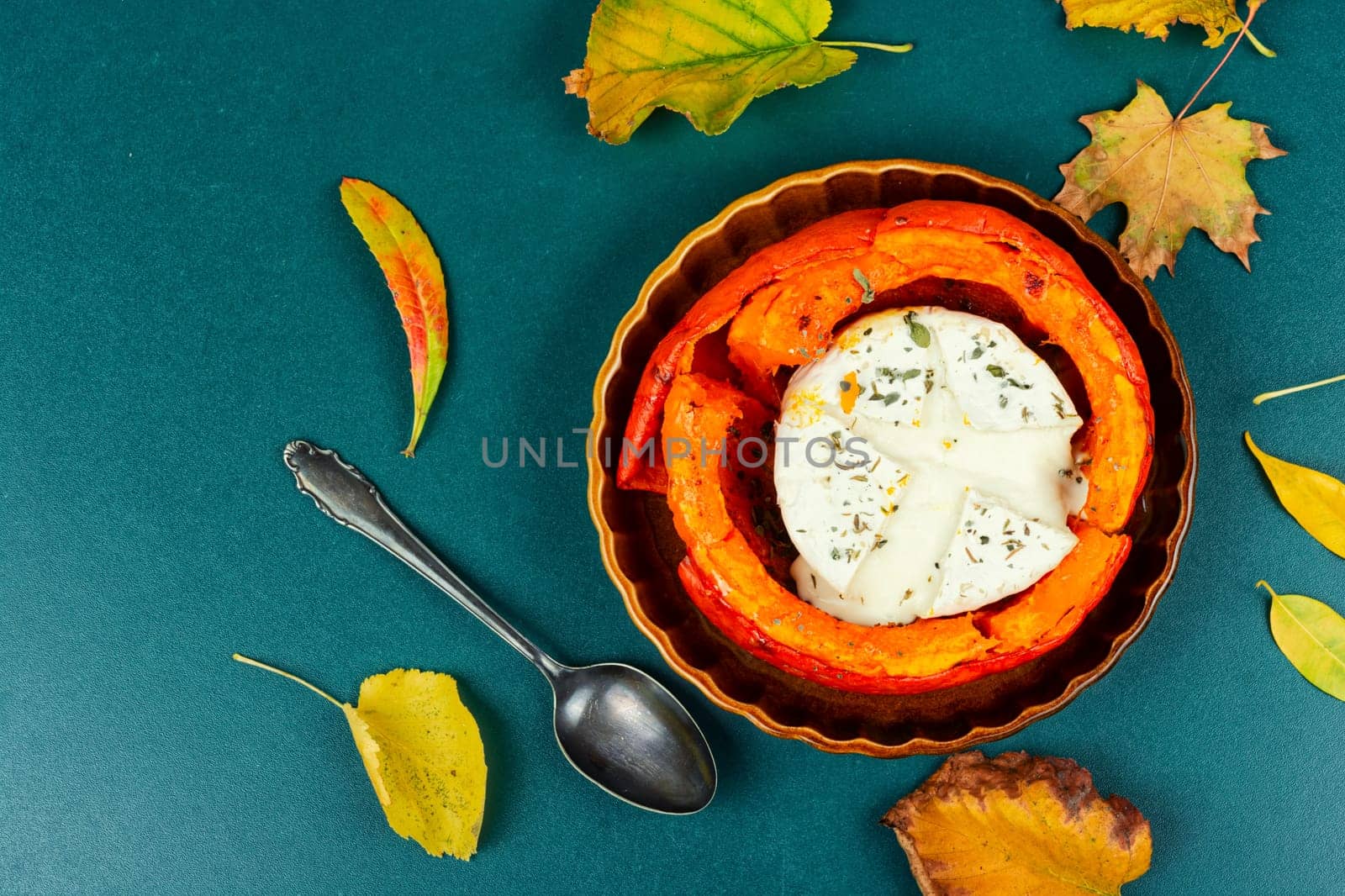 Halved roasted squash filled with spicy and camembert cheese.