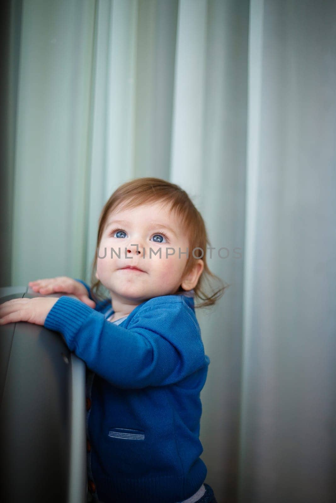 A young child is joyfully exploring and investigating their surroundings with a sense of wonder and curiosity