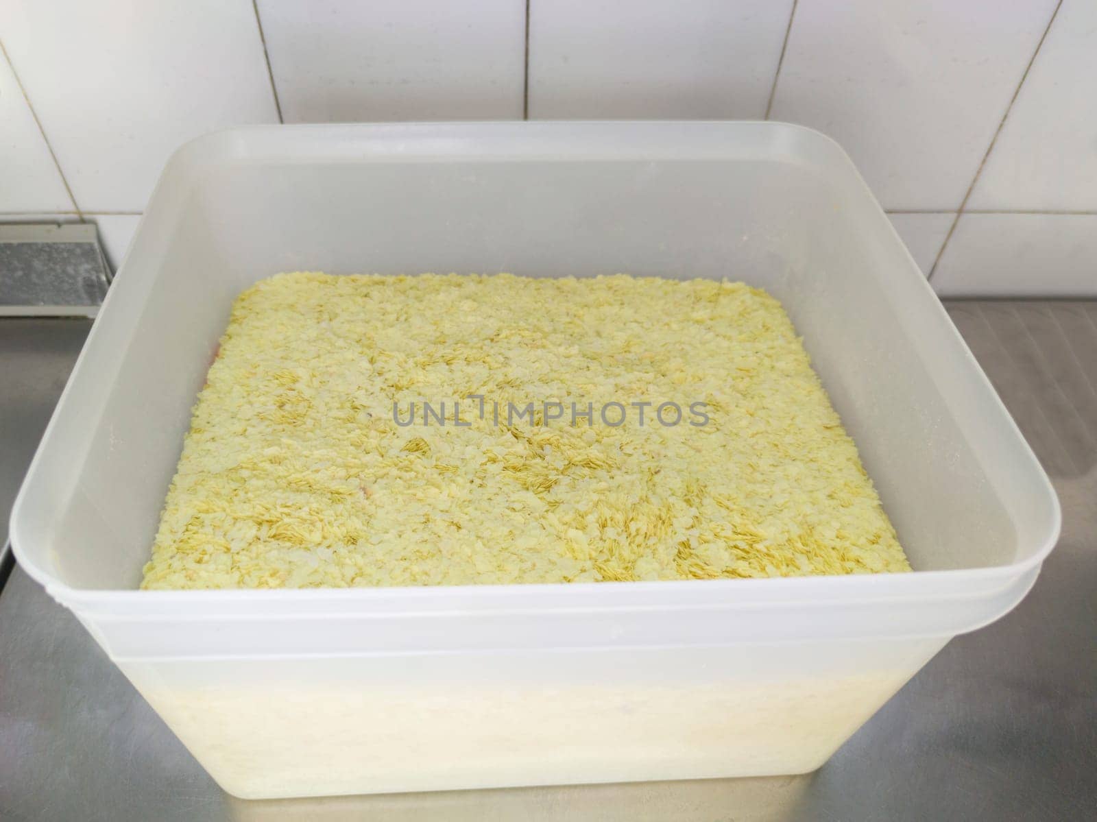 Professional Flaked instant mashed potatoes at plastic fiber container. Selective focus