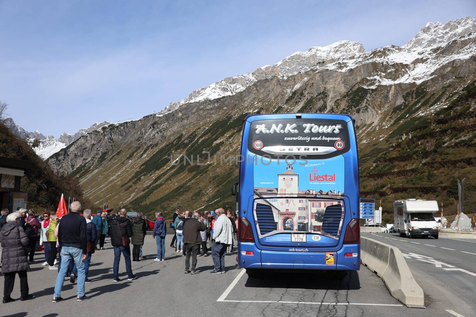 Tourists of a tour group with coach take a break on the Arlberg Pass in St. Christoph