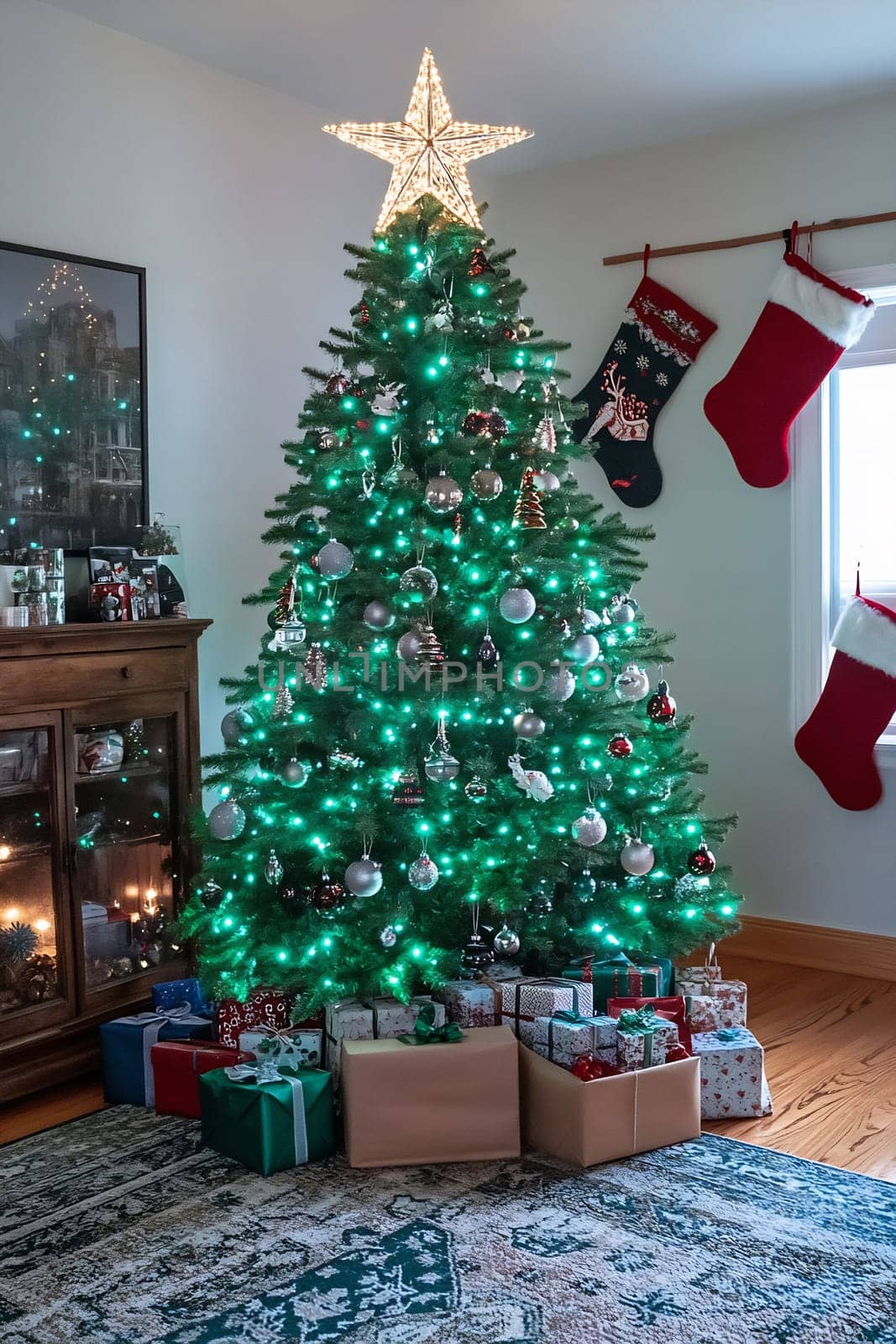 The Christmas tree, adorned with shimmering lights and ornaments, stands proudly with neatly wrapped gifts beneath it in a warm living room.