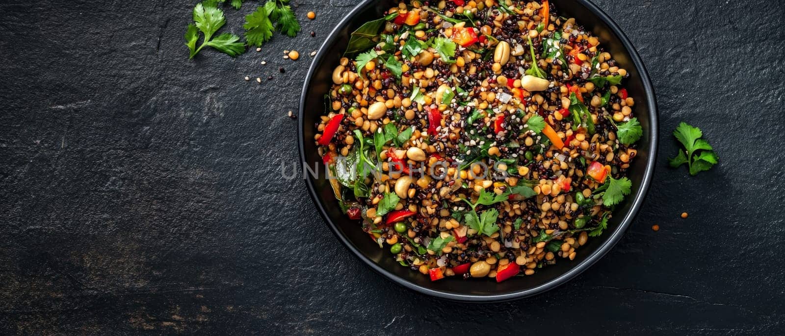 Vibrant bowl of mixed lentils and quinoa salad with colorful vegetables and herbs, showcasing a healthy, protein rich vegetarian meal on a dark background.