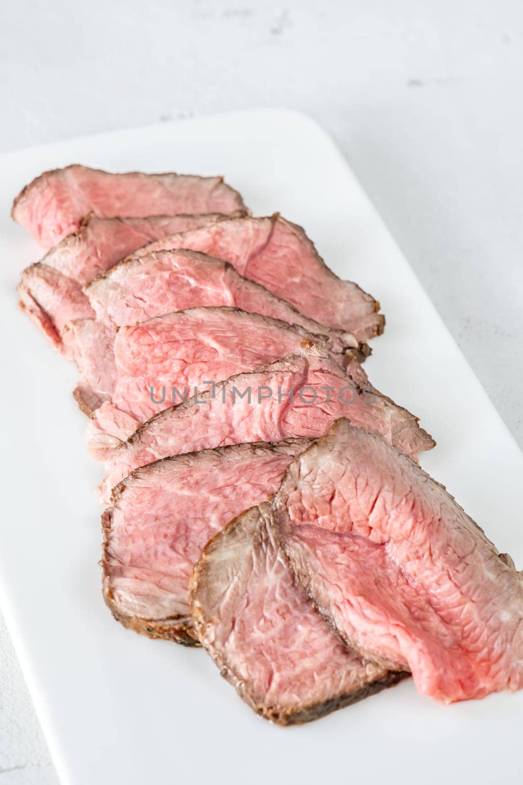 Portion of sliced roast beef on the plate