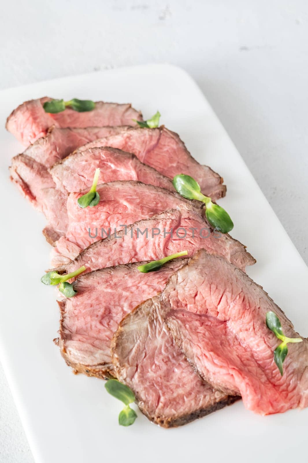 Portion of sliced roast beef on the plate