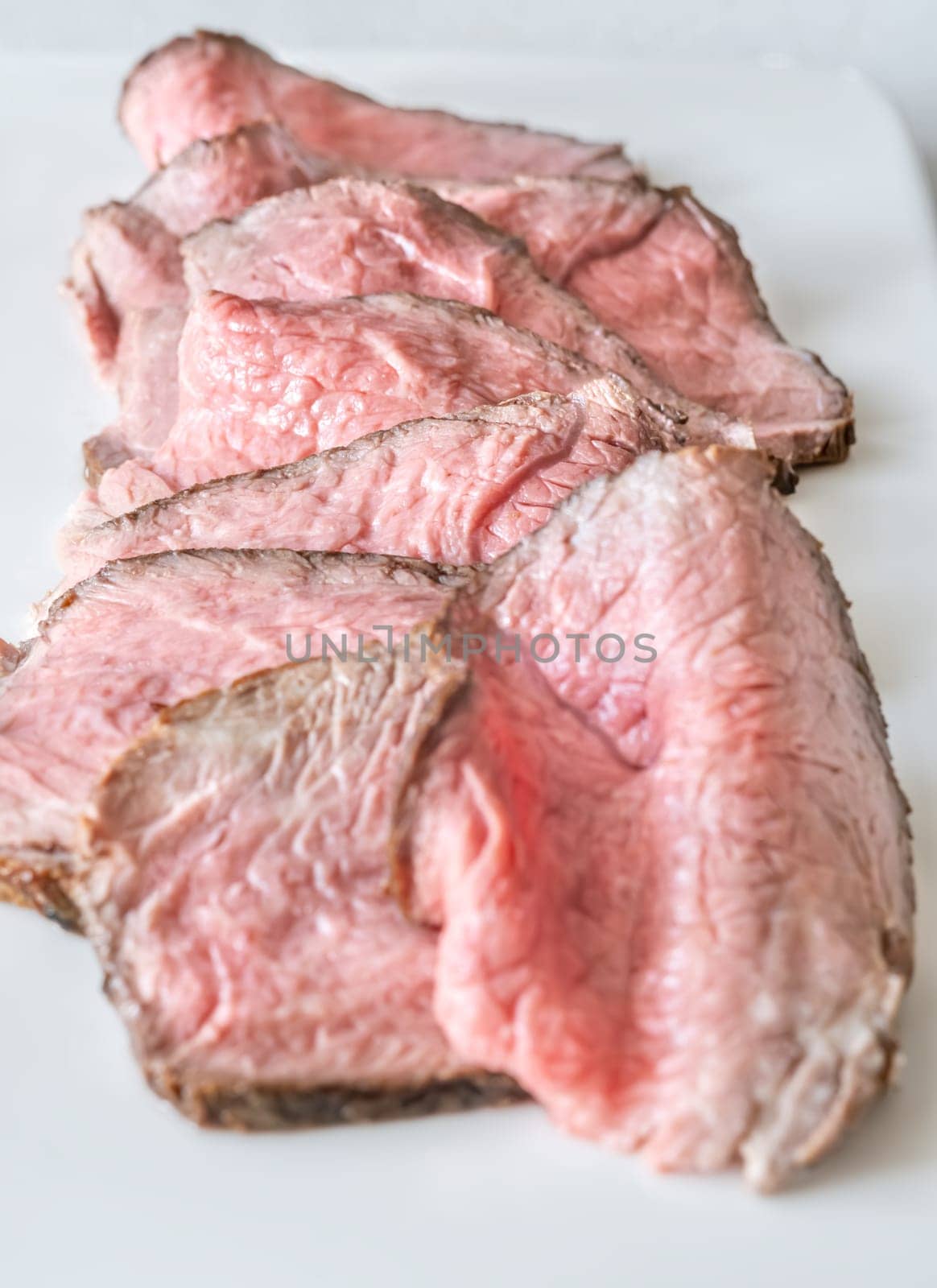 Portion of sliced roast beef on the plate