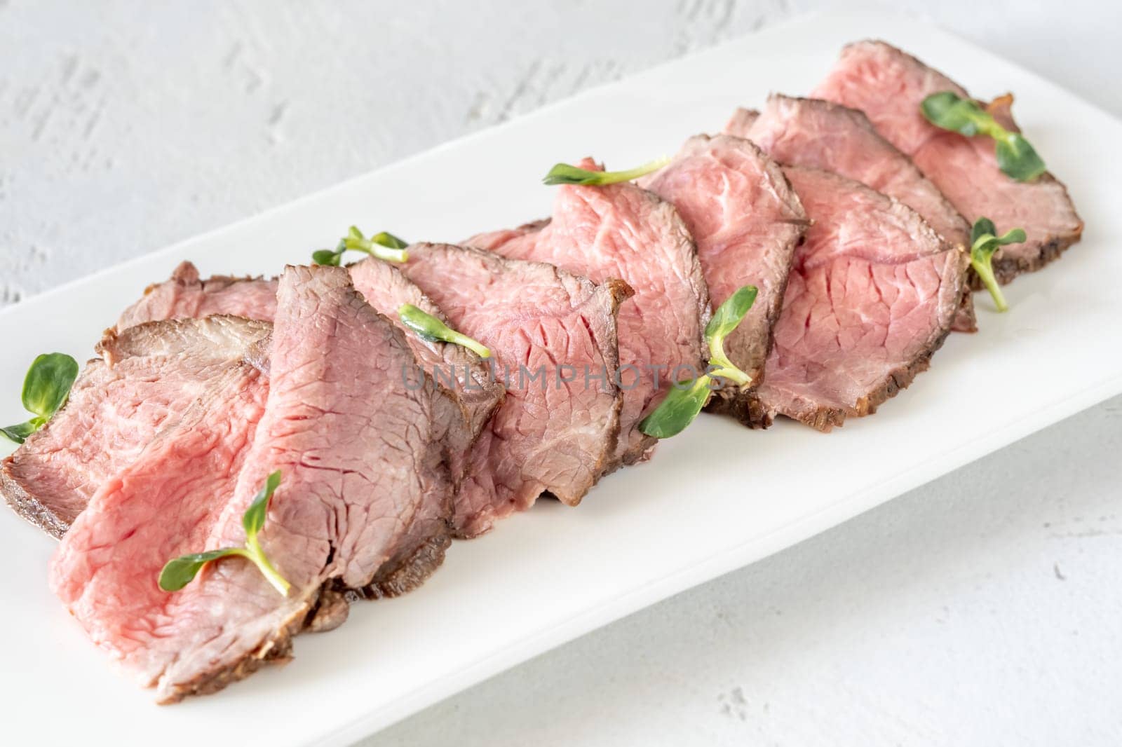 Portion of sliced roast beef on the plate