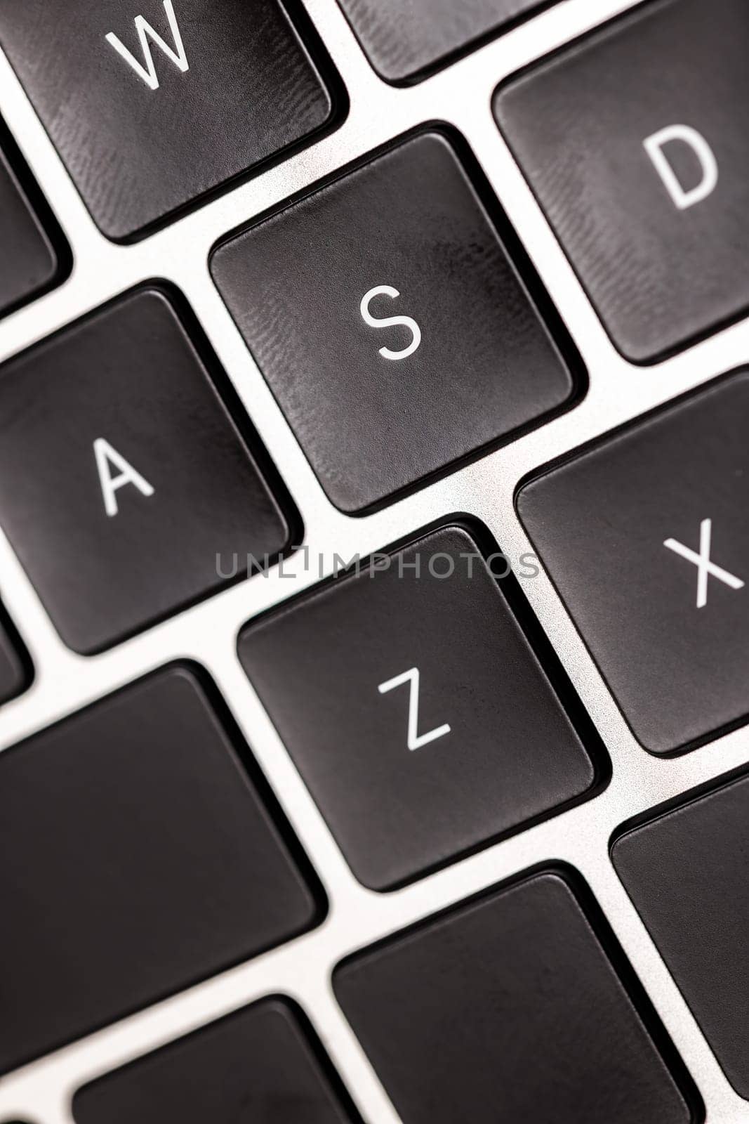keyboard of famous silver colored laptop with fingerprints, closeup