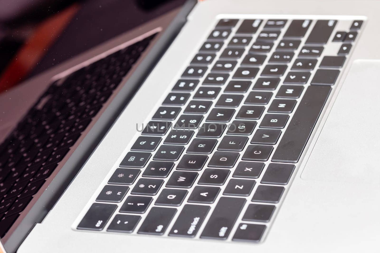 keyboard of famous silver colored laptop with fingerprints, closeup
