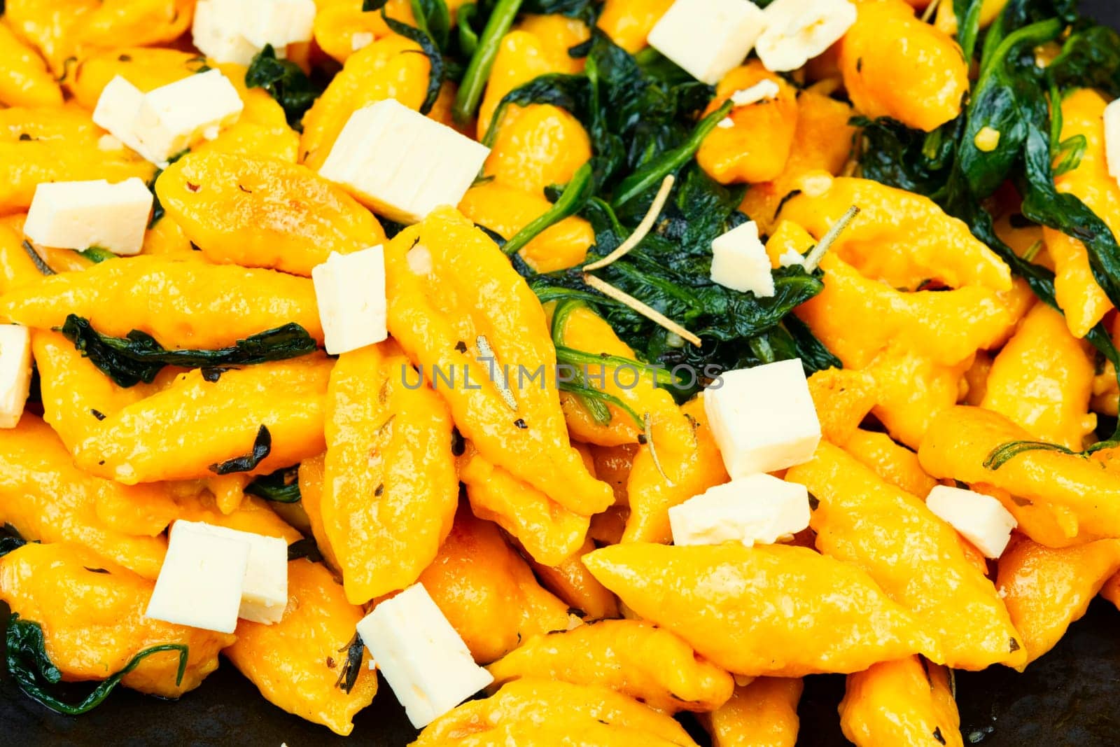 Autumn meal. Plate of homemade pumpkin ravioli or dumplings. Vareniki from pumpkin dough.