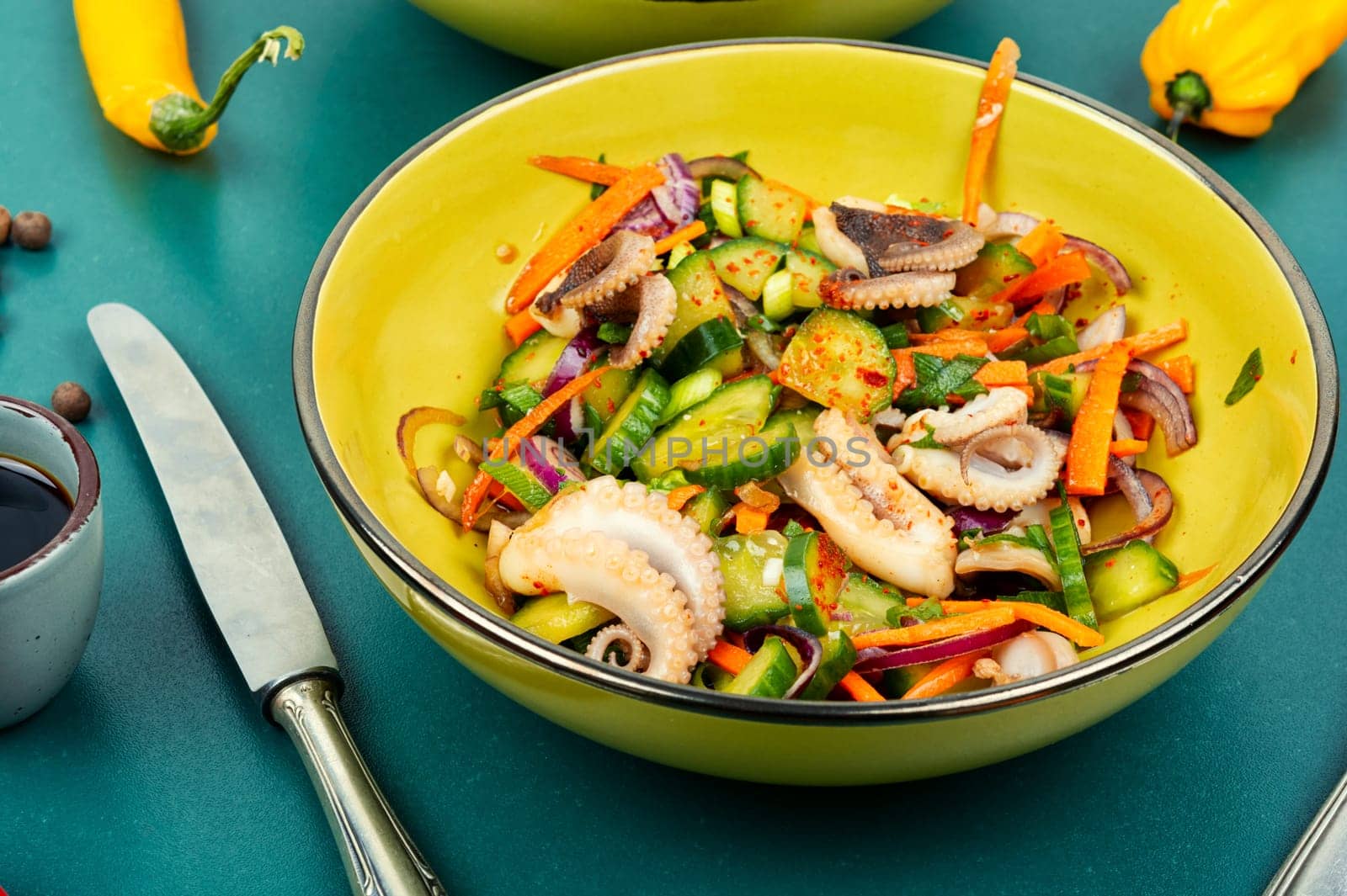 Thai spicy squid or calamari salad in plate. Summer food menu.