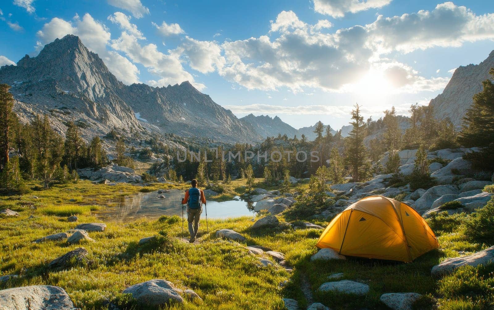 Lone hiker with backpack standing near yellow tent, admiring scenic mountain landscape with lake and forest, embodying adventure and outdoor lifestyle.