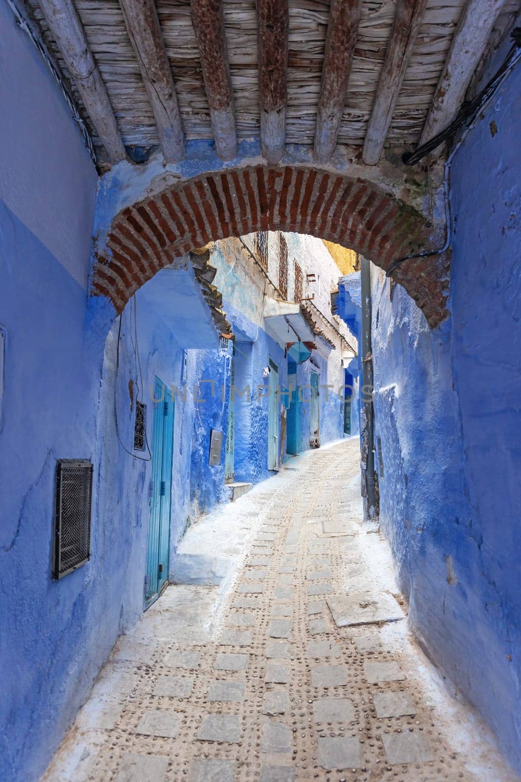 Archway in a blue narrow alley in the city of Chefchaouen. Morocco.