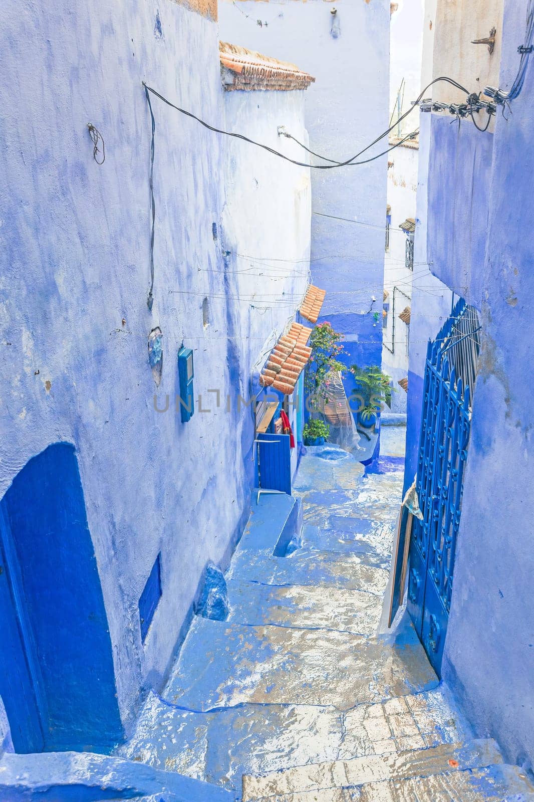 Empty blue street in a blue city of Chefchaouen. Morocco. Vertically.