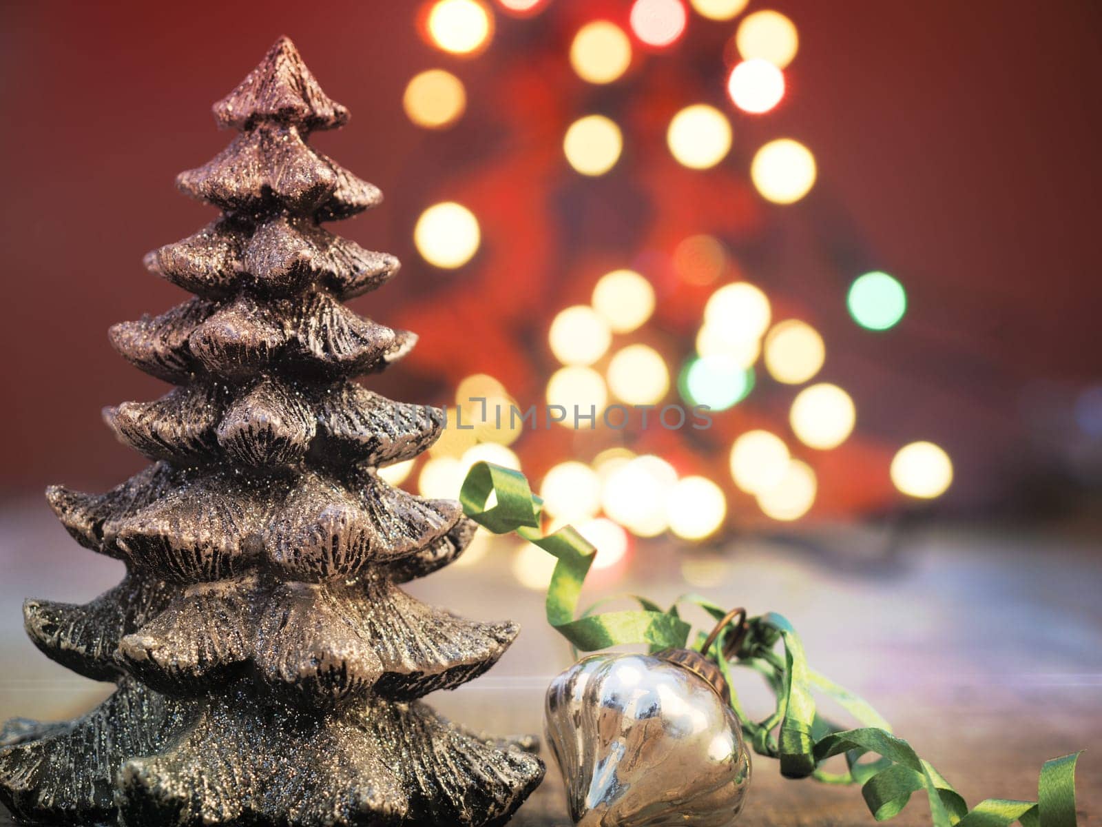 Christmas tree shape with Christmas bauble on a blurred Christmas lights background