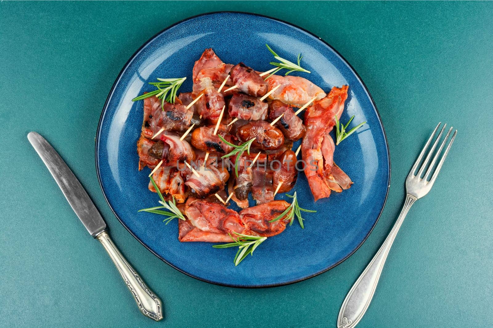 Homemade sweet and savory bacon wrapped dates served on a platter. Rustic style.