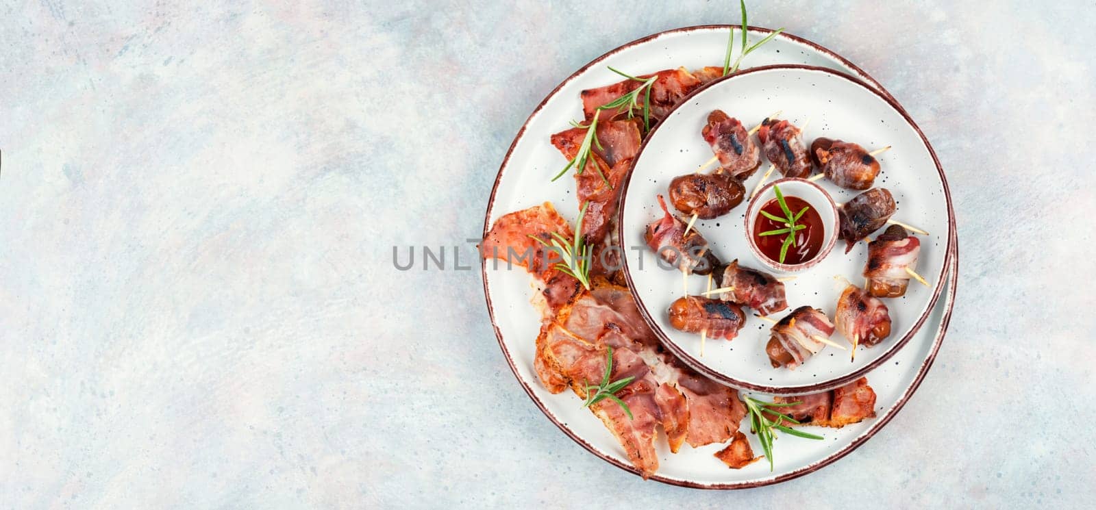 Homemade sweet and savory bacon wrapped dates served on a platter. Rustic style.