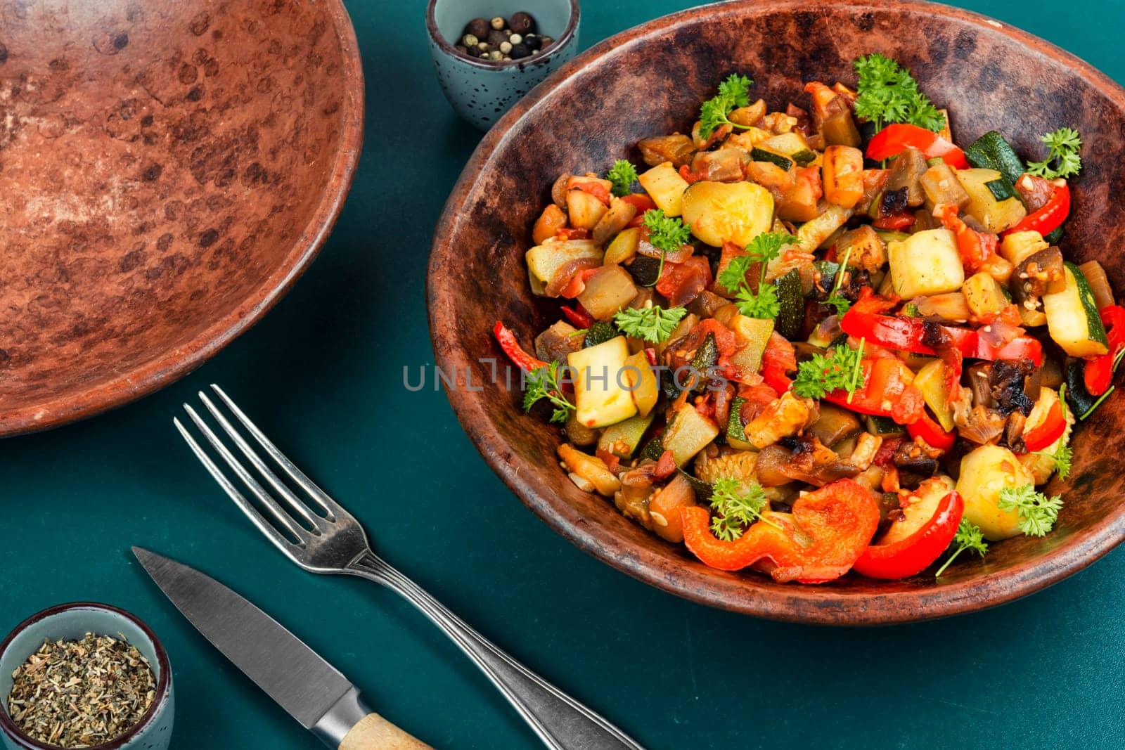 French vegetable dish, ratatouille. Baked eggplants, zucchini, peppers and tomatoes.